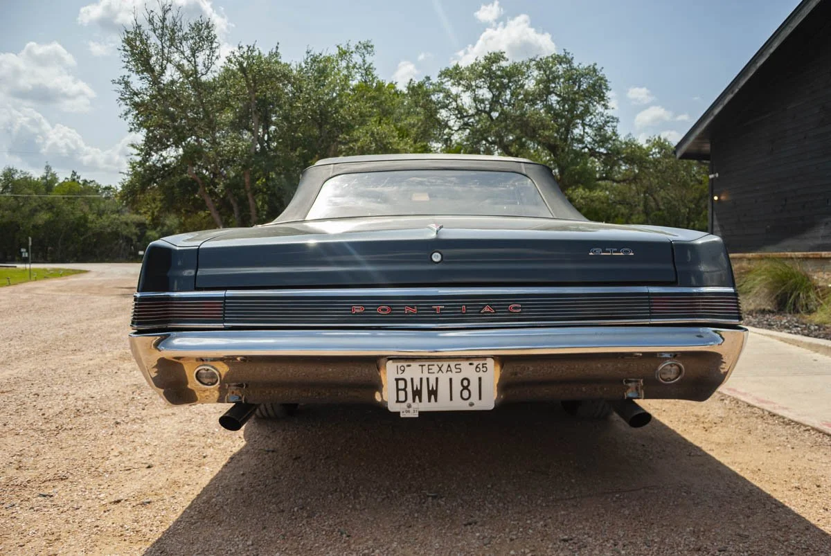 Rear view of a charcoal 1965 Pontiac GTO convertible