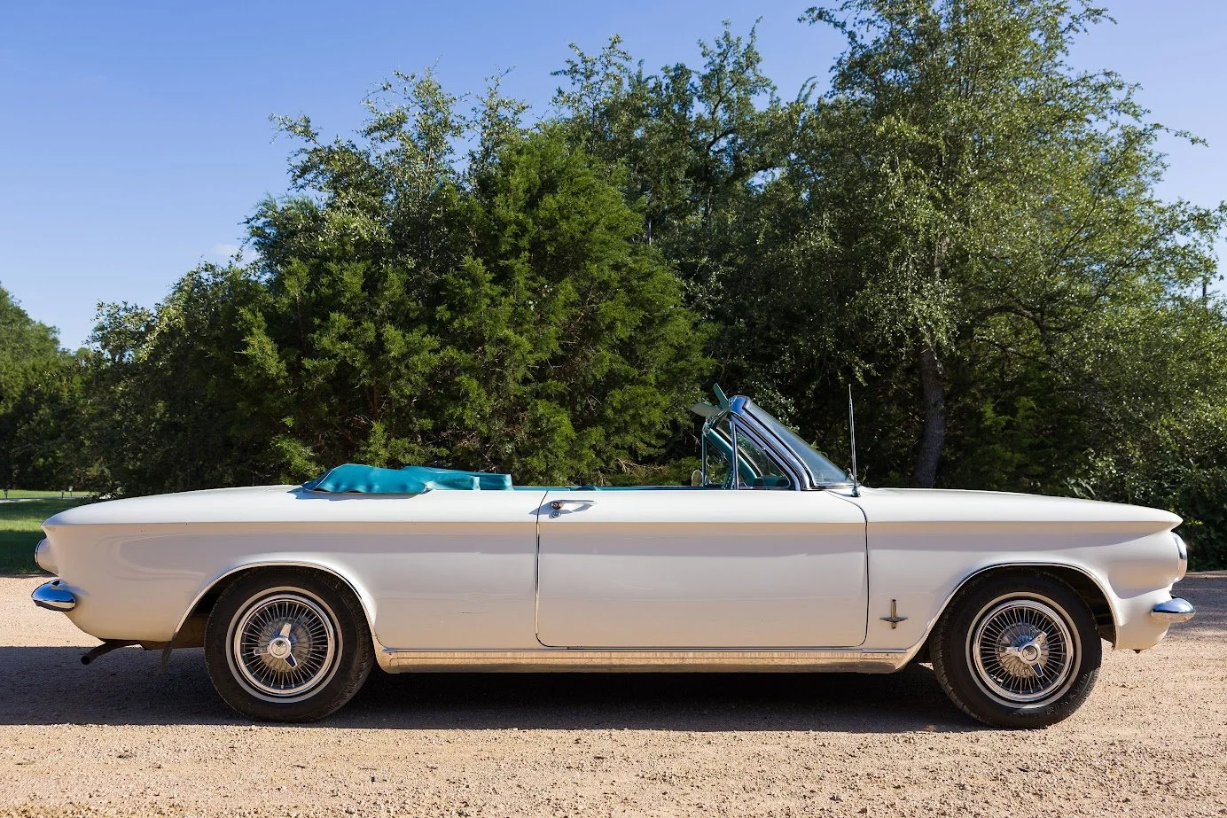 White 1964 Chevy Corvair convertible with a teal top boot, chauffeur-driven rental in Dripping Springs TX