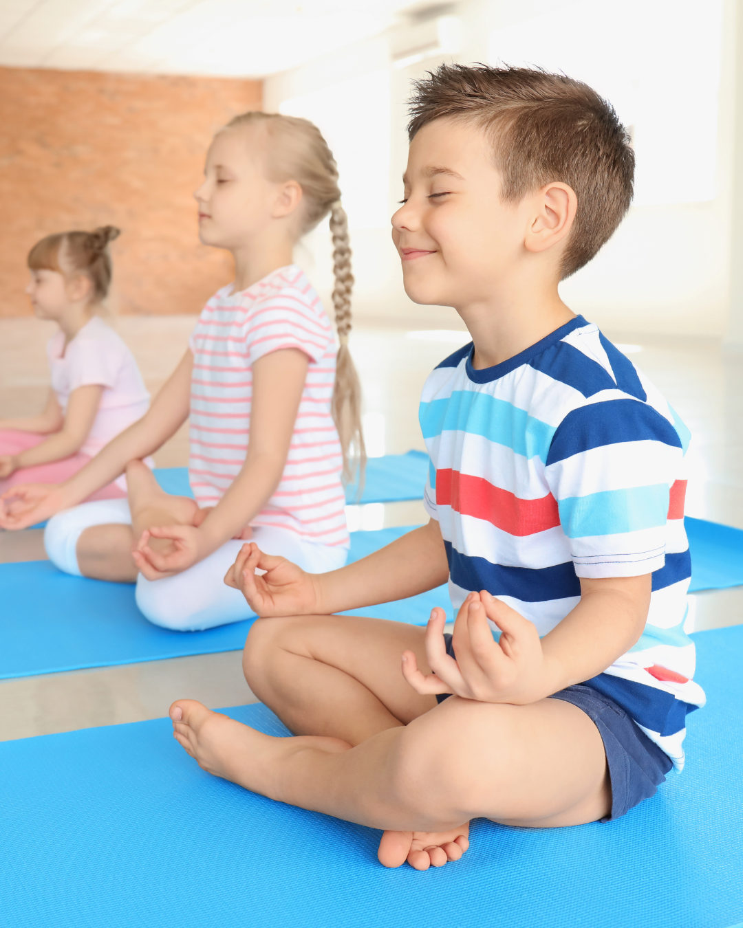 Elementary age children practicing mindfulness meditation during a kids yoga class in New Brighton Minnesota