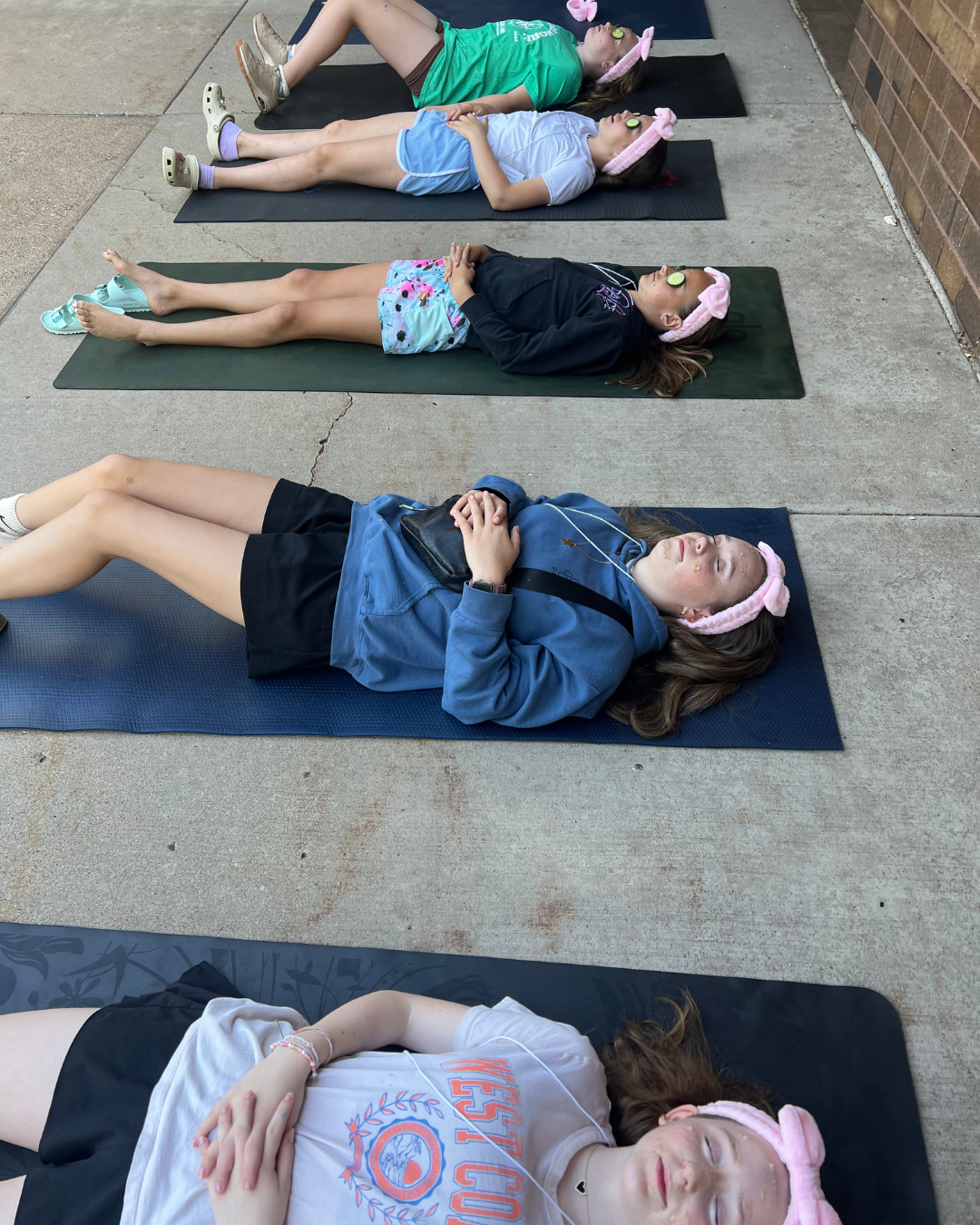 Children practicing quiet breathing in nature at a summer camp in the Mounds View area.
