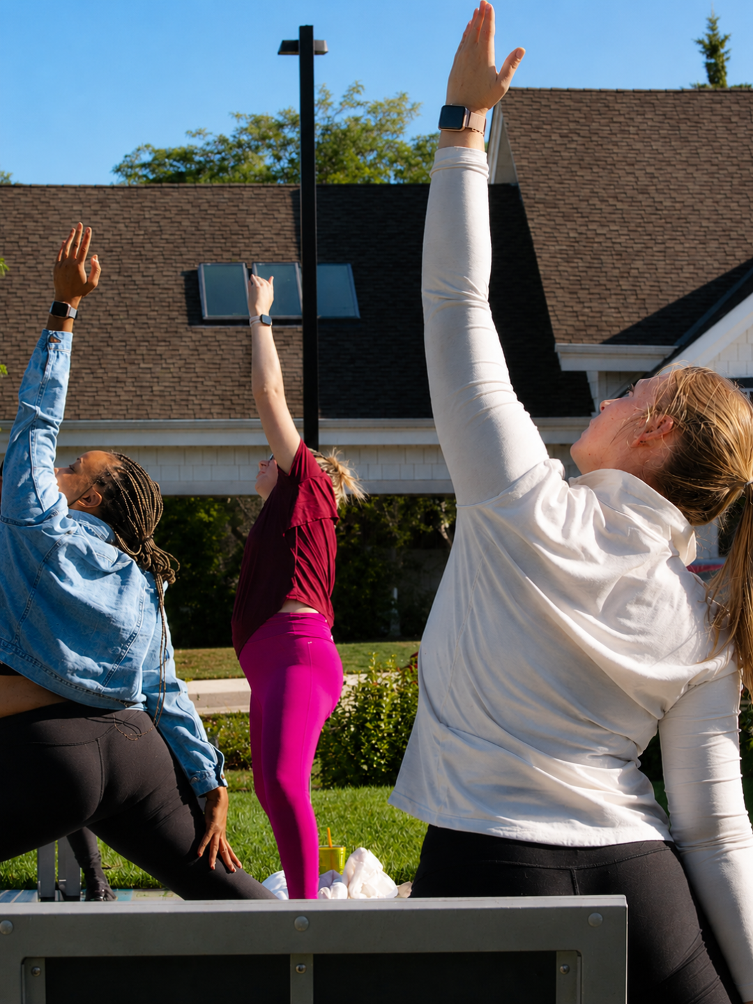 Adults reaching arms overhead in outdoor yoga class at The Mindfulness Movement in Shoreview Minnesota