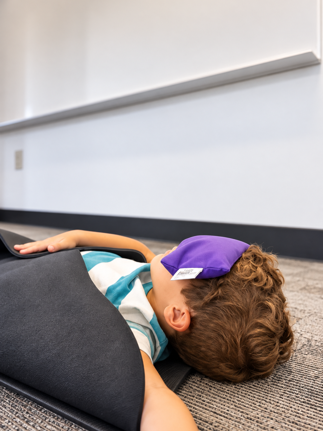 Child resting with a lavender eye pillow during a guided relaxation