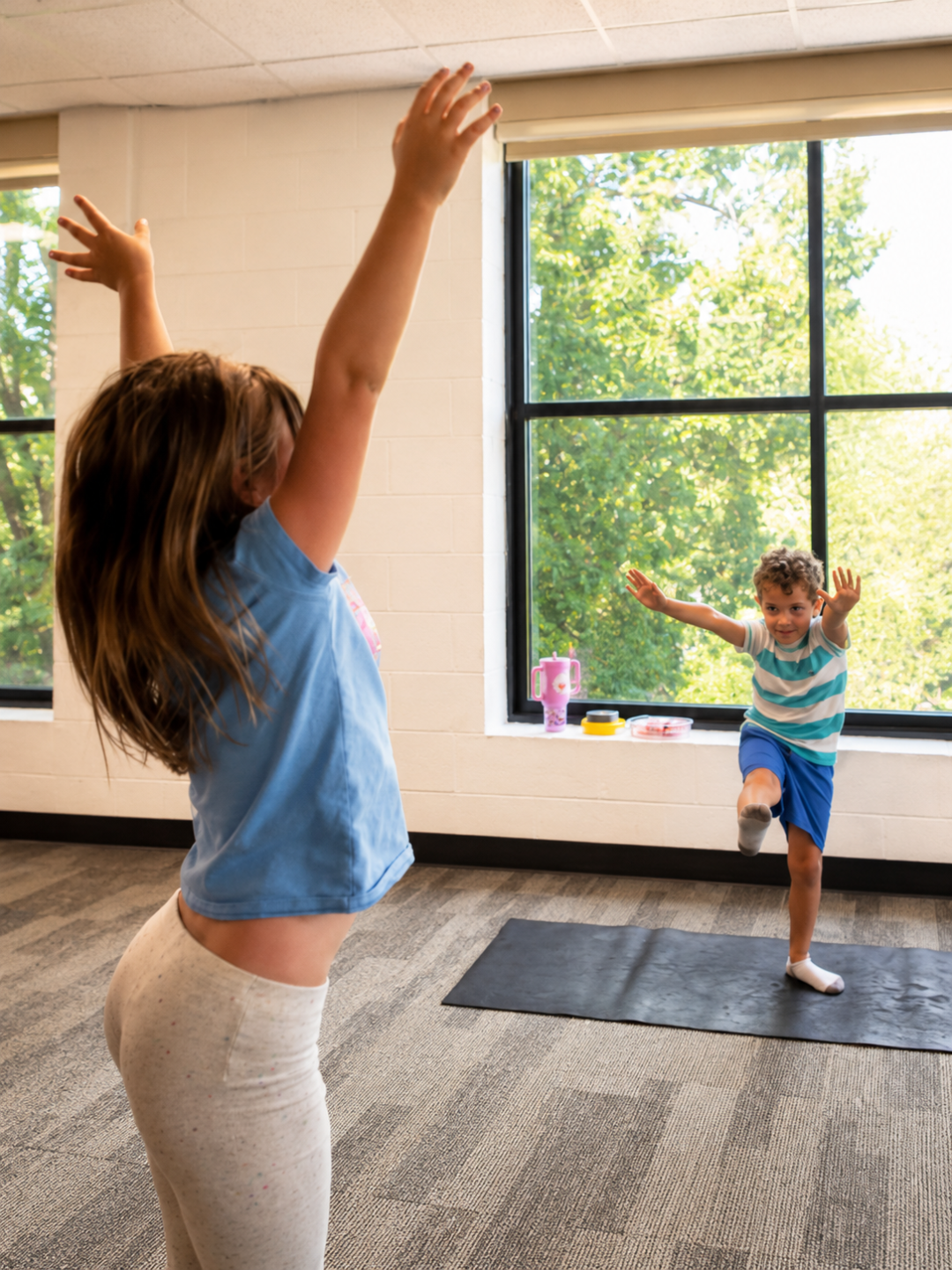 Educator and child looking at a Mindful Movement Kids collectible badge
