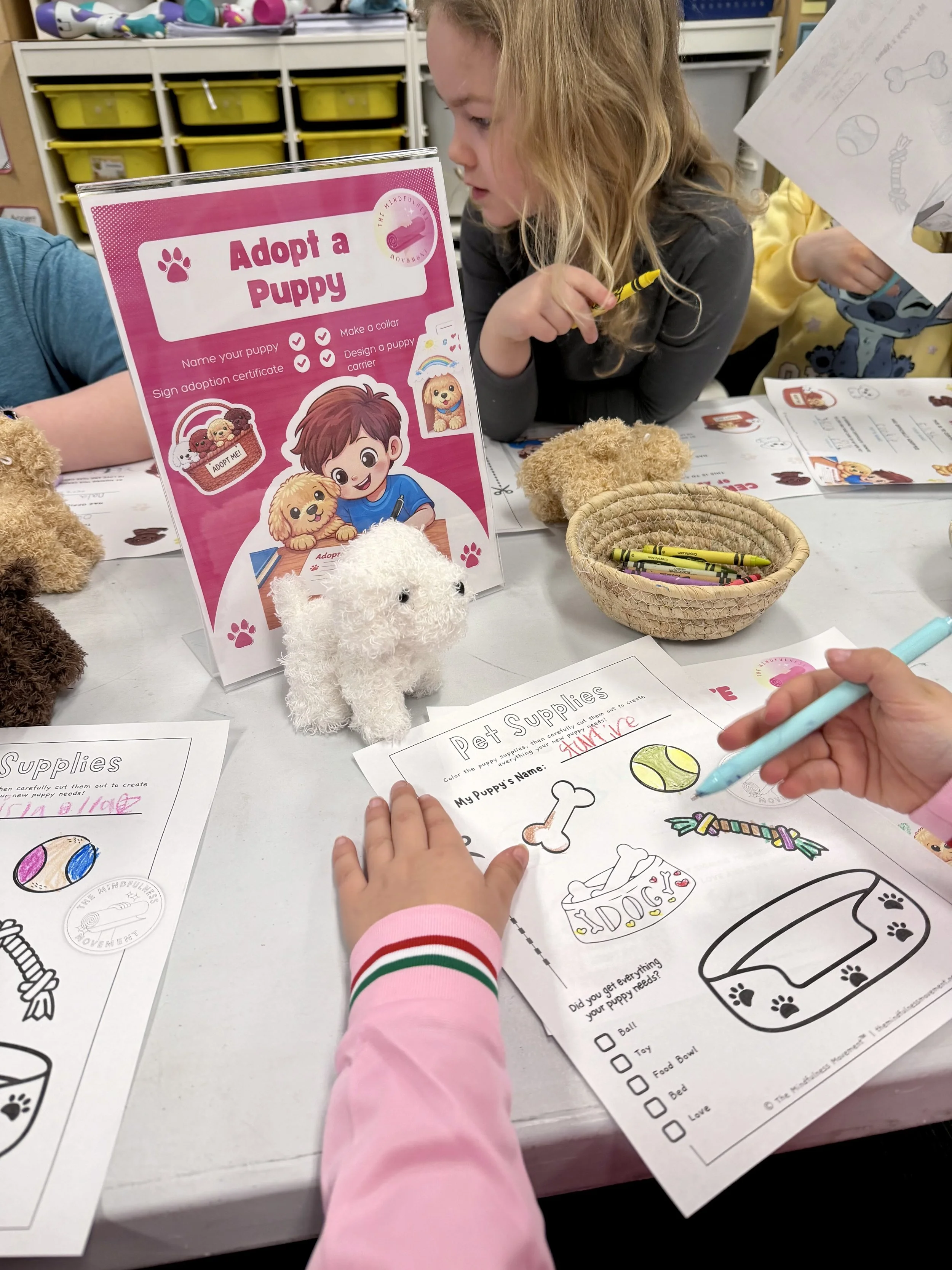Children completing an “Adopt a Puppy” craft activity during a kids Puppy Yoga and mindfulness retreat in Minnesota.