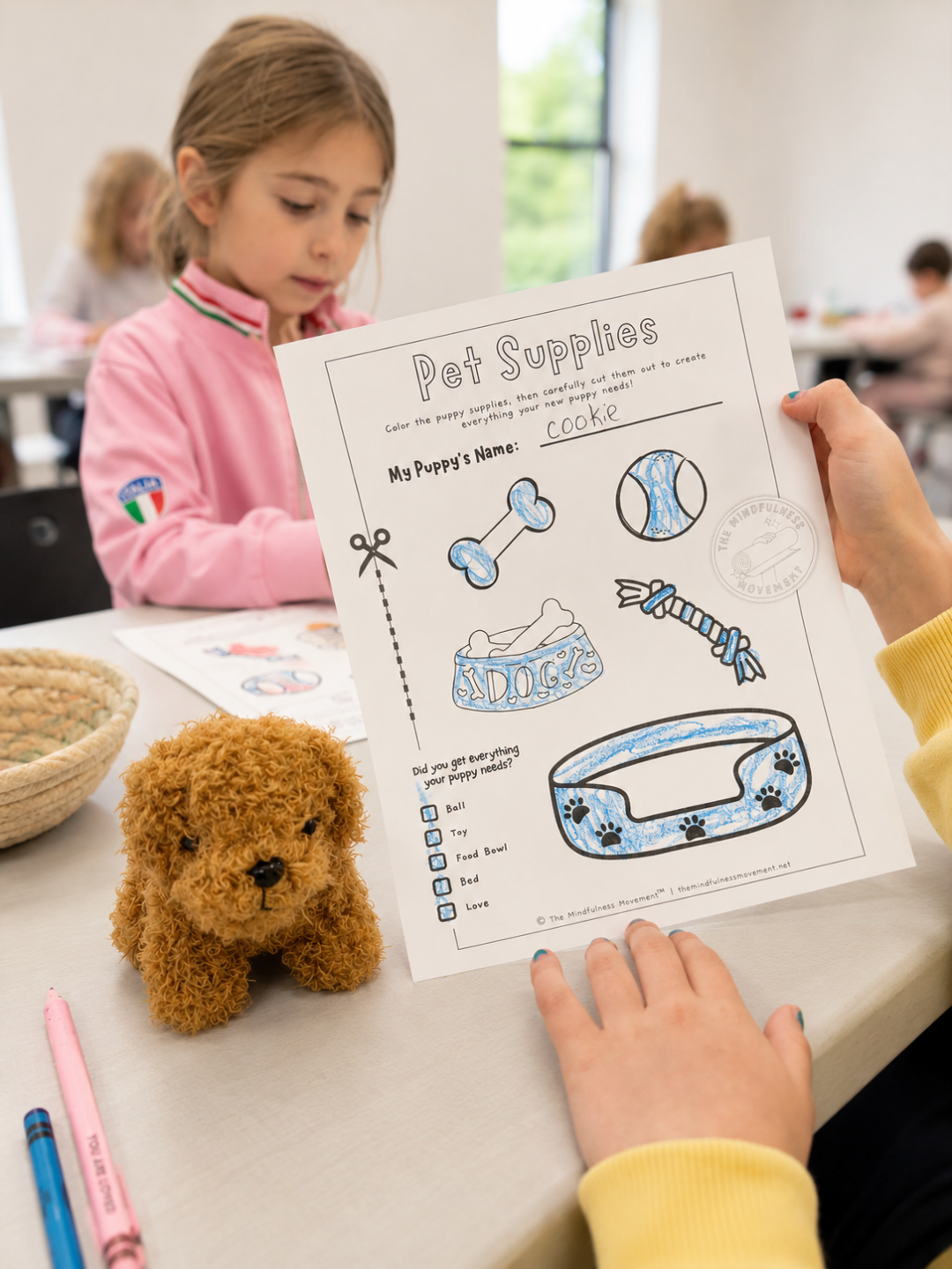 Kids coloring and completing an Adopt a Puppy activity sheet at a Puppy Yoga camp craft station in New Brighton, MN.
