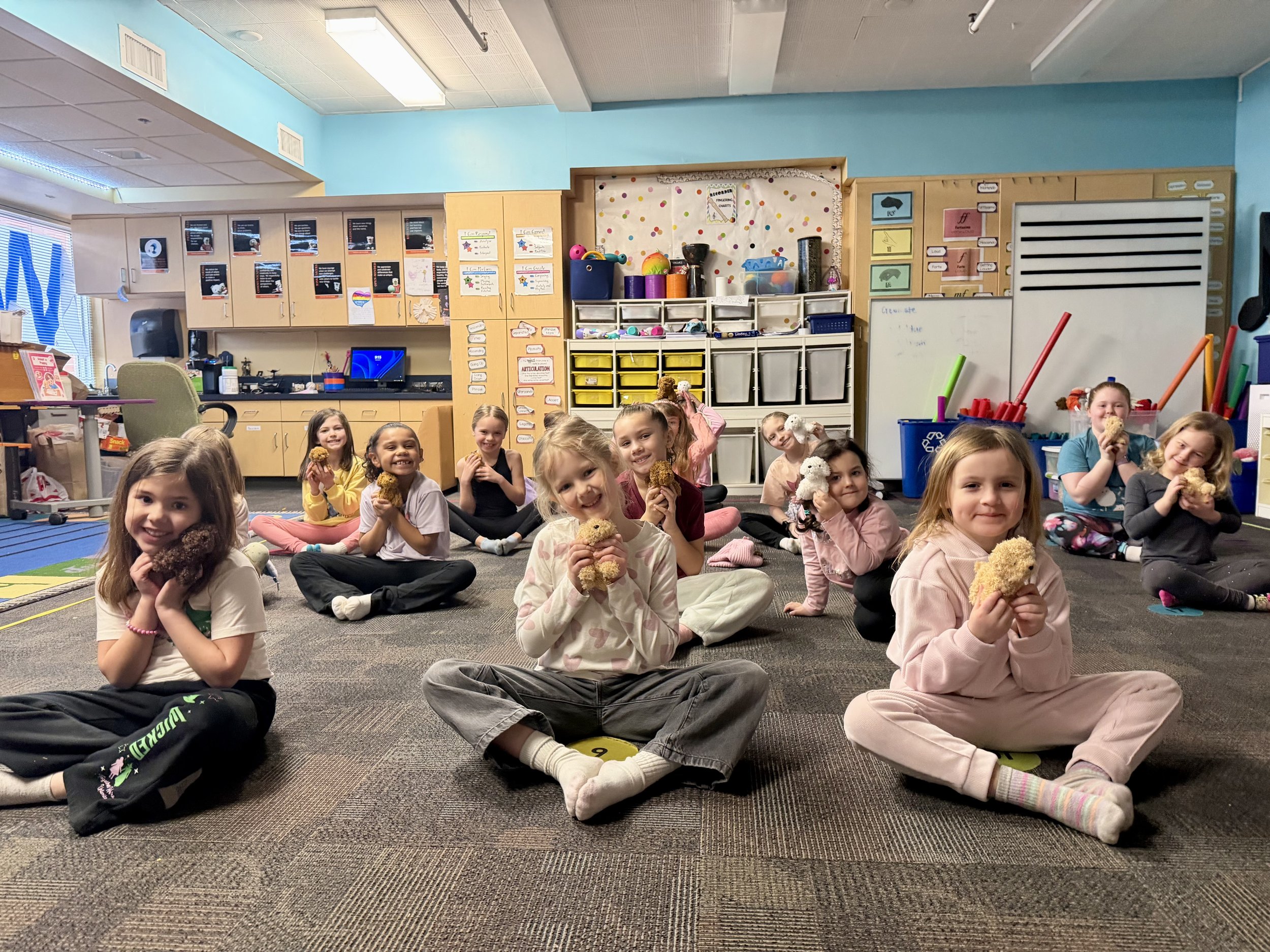 Children participating in a Puppy Yoga class at a Pose & Play™ kids yoga retreat in the Twin Cities area of Minnesota.