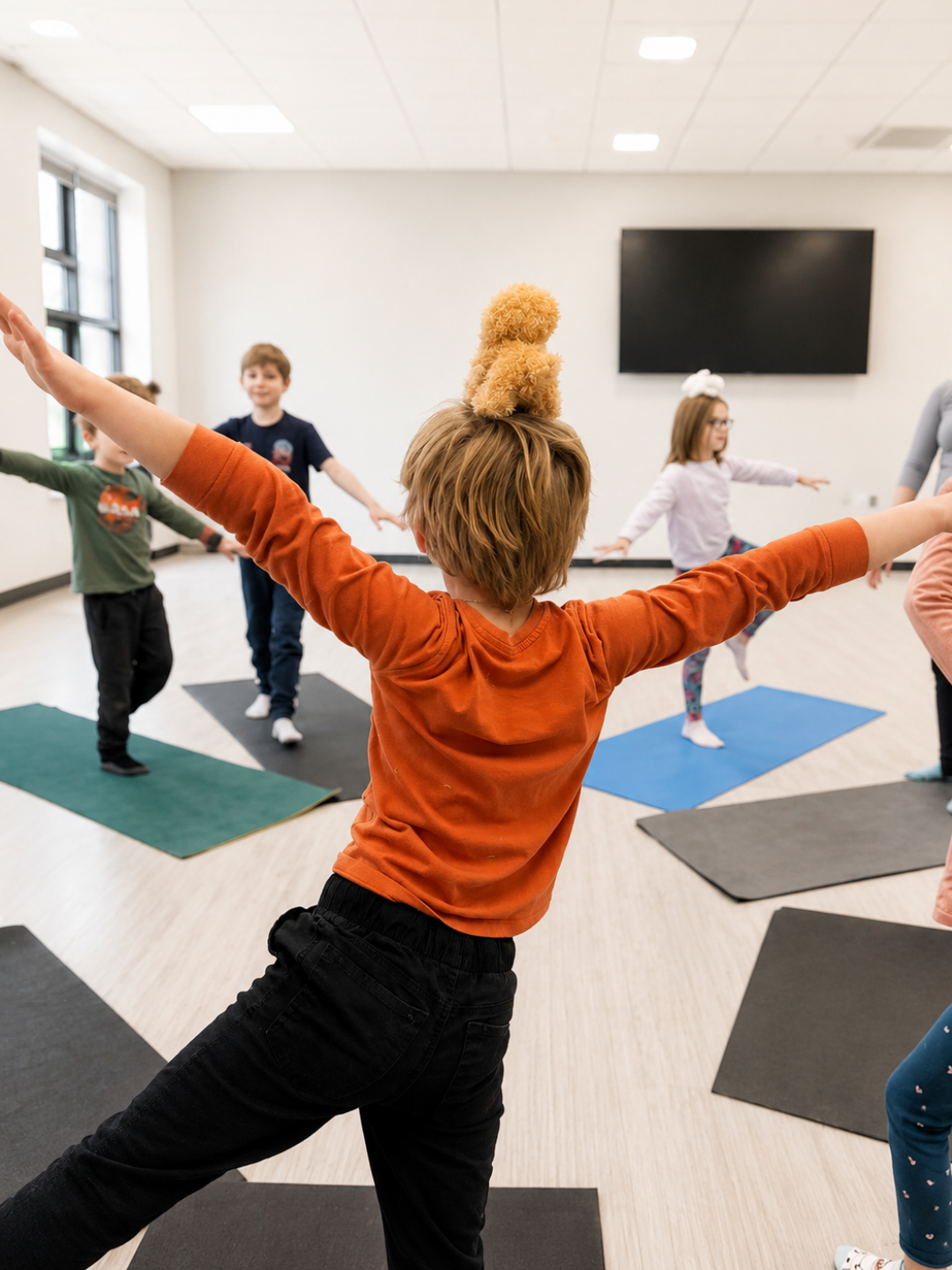 Children doing warrior yoga poses at a kids puppy yoga camp in New Brighton, Minnesota, hosted by The Mindfulness Movement.
