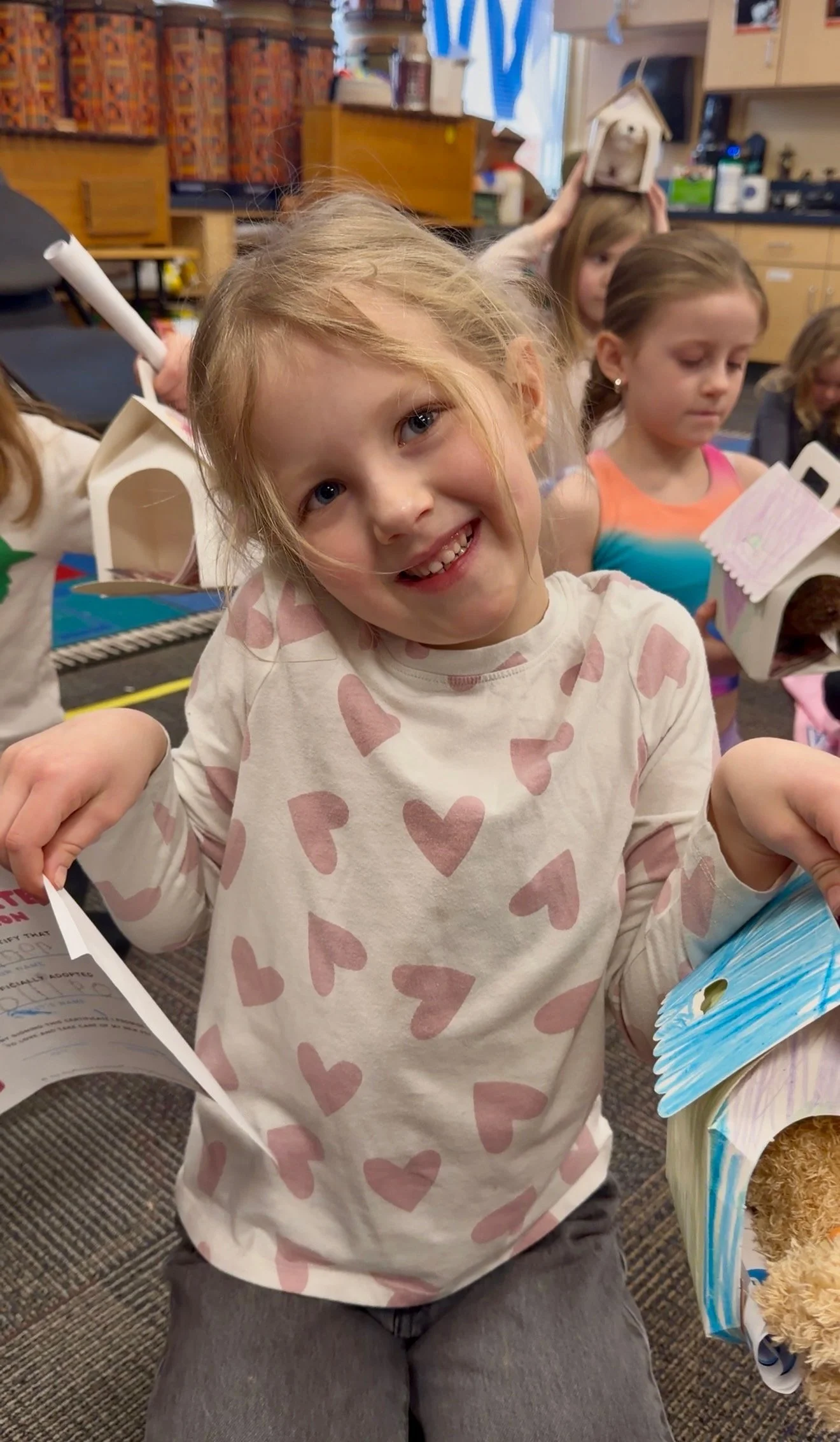Child smiling during a Pose & Play™ Puppy Yoga retreat for kids in Minnesota, a playful kids yoga and mindfulness camp experience.