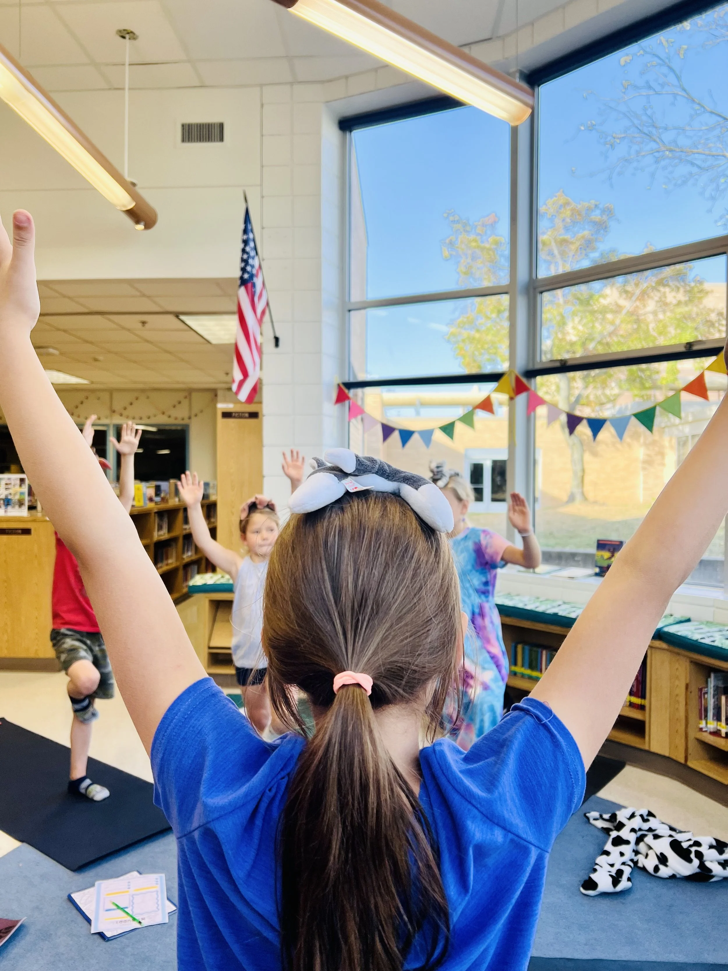 Kids practicing yoga with arms outstretched during mindfulness class at Turtle Lake Elementary School in Mounds View MN