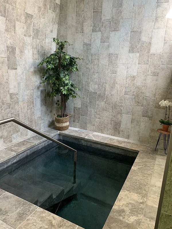 An overhead view of the beautifully tiled mikvah, showcasing the stairs entering the Louisiana Community  mikvah.