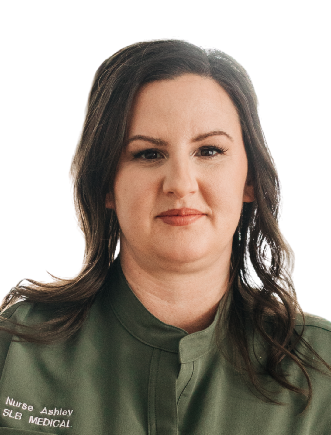 A woman with a nose piercing and black earrings, wearing a yellow top, smiling slightly, with a white background.