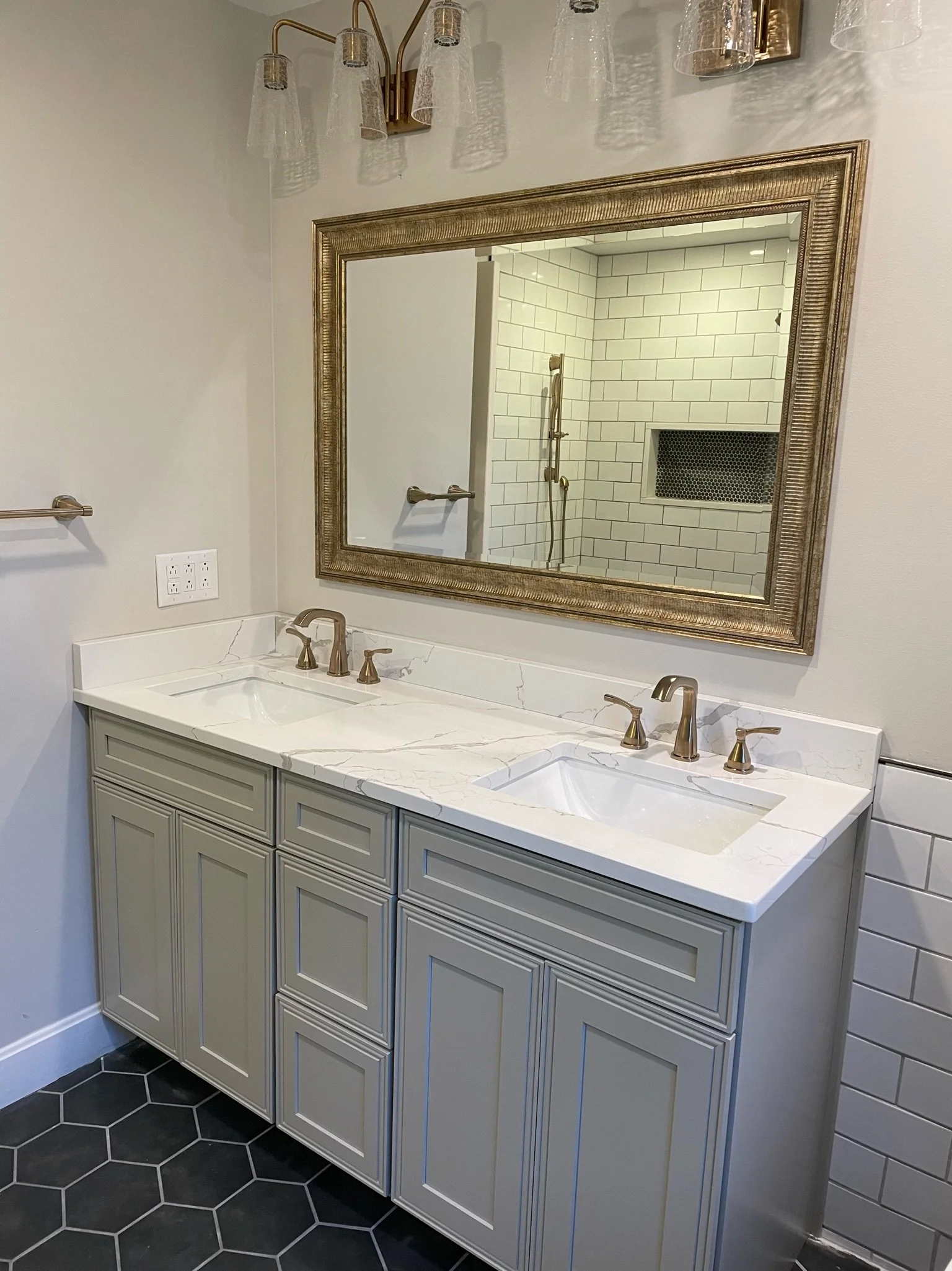 Double sink, lights, mirror, and floor