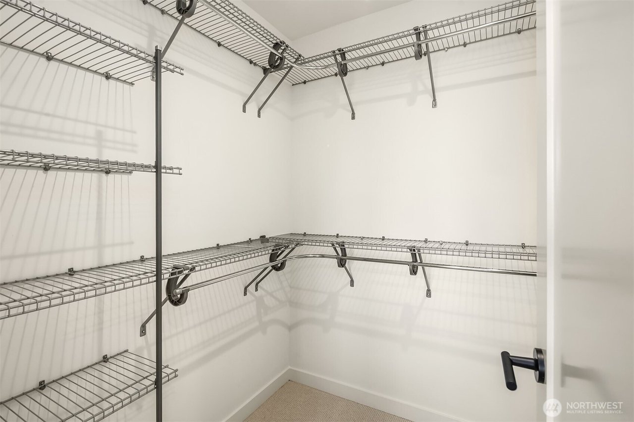 Empty walk-in closet with metal wire shelving on walls.