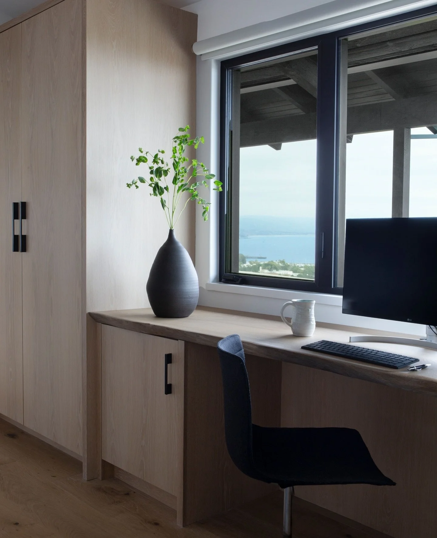 A desk with a view! Our client wanted to take full advantage of the incredible views, while working in her home office space, which also doubles as a guest bedroom. The live edge desktop softened the edges of the flanking built-in storage and guest c