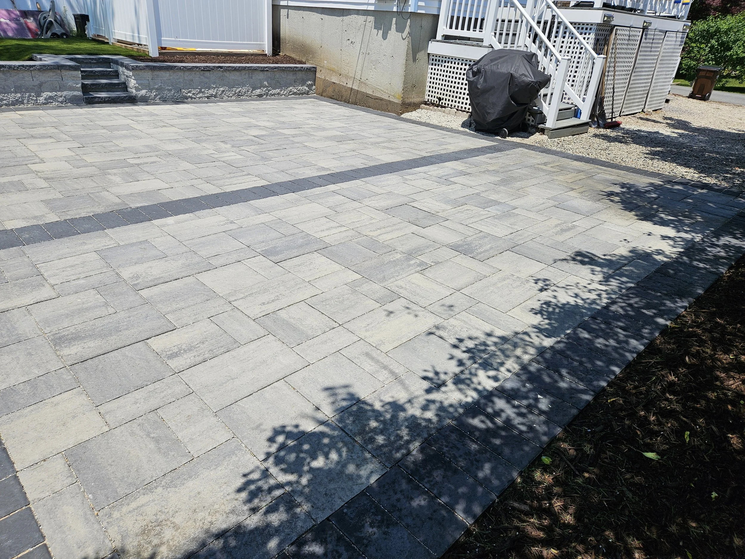 The driveway runs up to the patio border for a seamless transition.