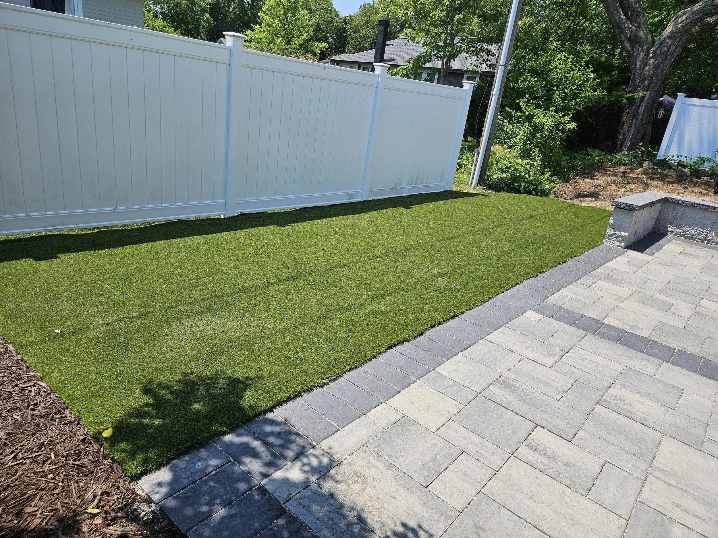 Turf borders the patio to reduce maintenance.