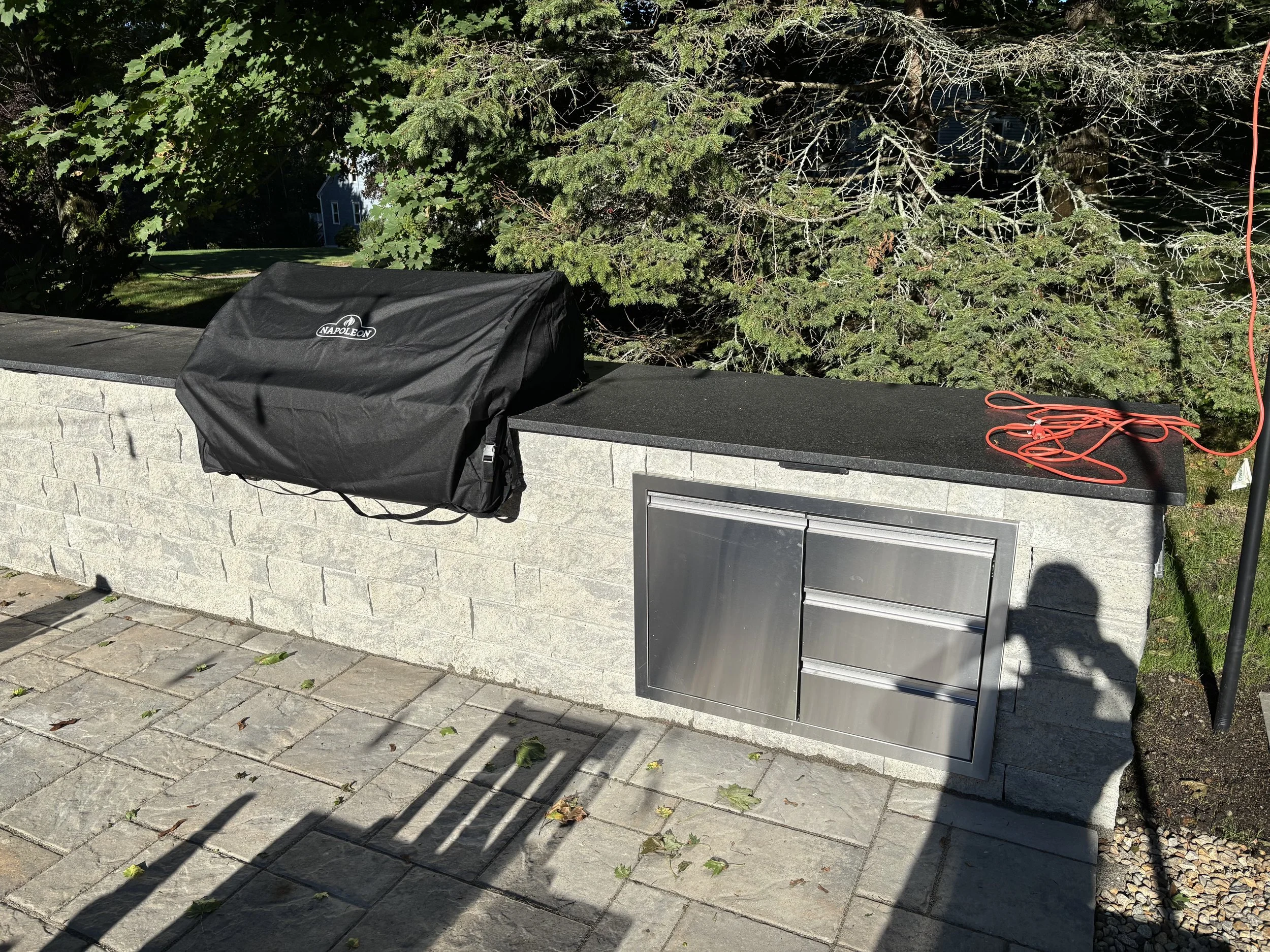 Solid countertop added for the outdoor kitchen creates plenty of prep space for grilling