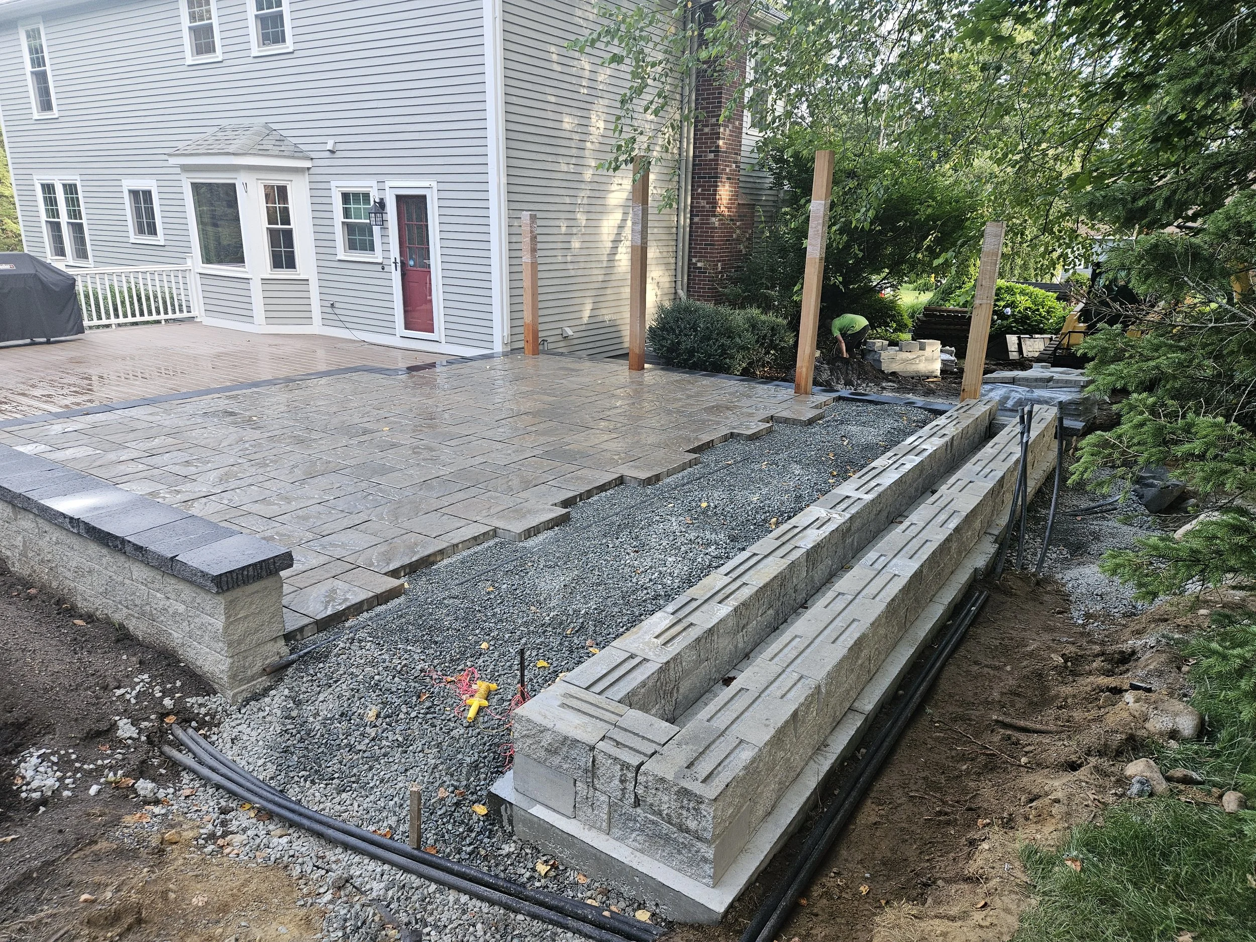 Base for the outdoor kitchen and posts for TV wall added
