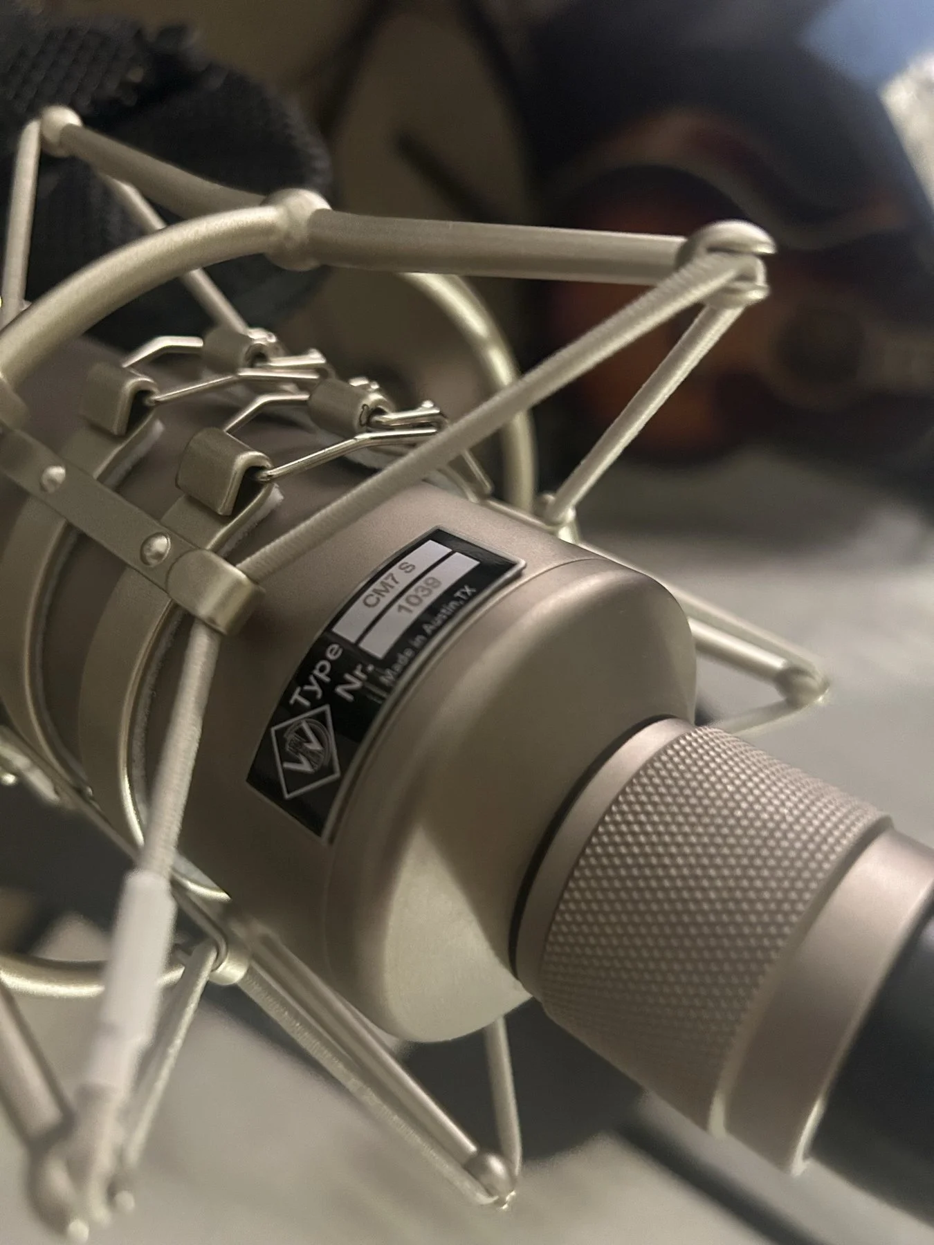 A studio microphone in its shock mount