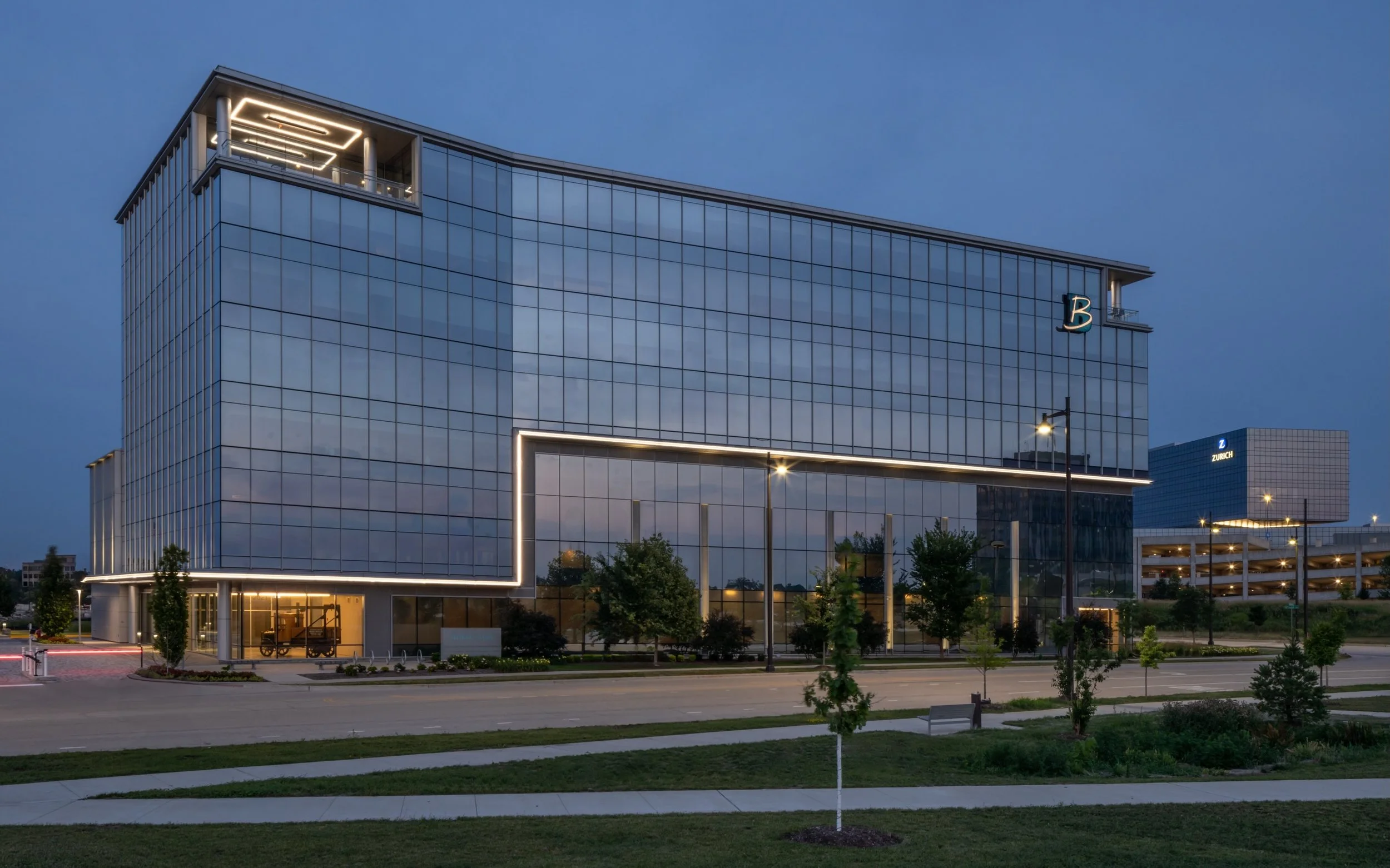 Glass,reflections,and the last light of the day.  While photographing The Boler Company HQ in Schaumburg , IL  i was drawn to how the warm lighting traces the building edges against the blue sky.
I wanted to capture both its overall presence and quie