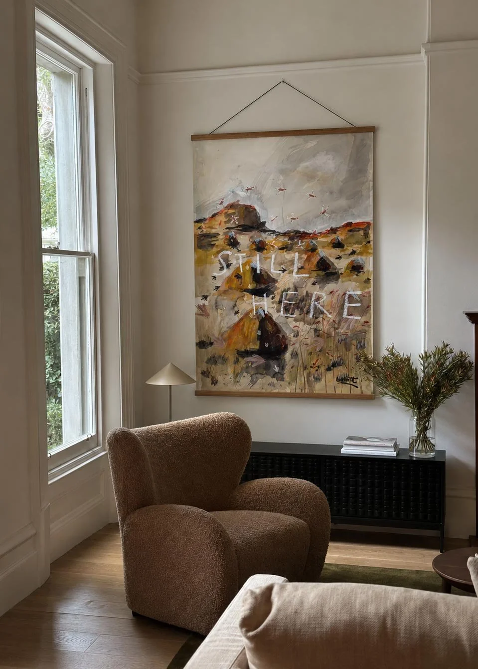Still Here — open edition print hanging in a Brunswick living room
