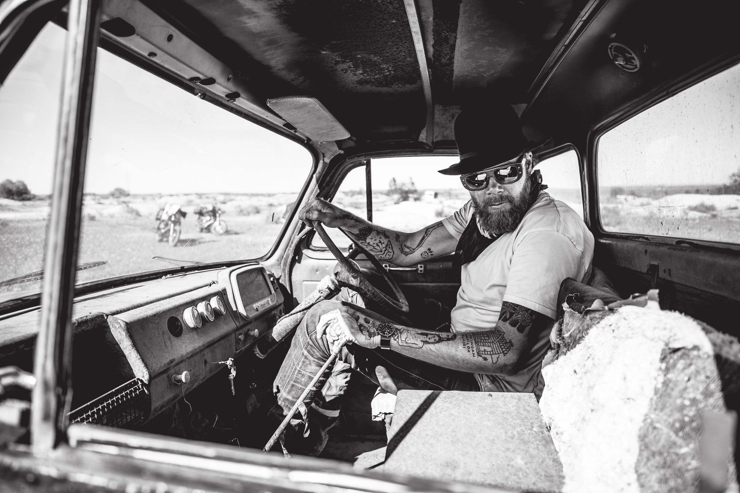 Michael Lelliott at the wheel of an old truck, somewhere off the map