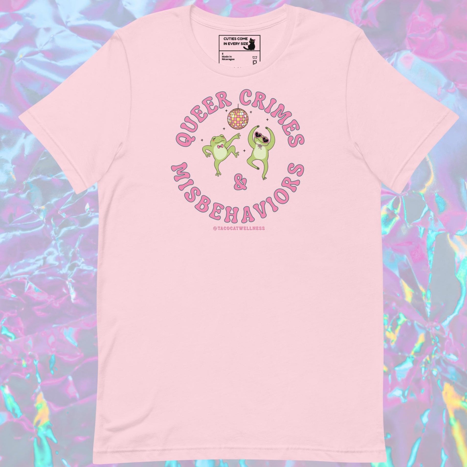 Two illustrated green frogs are dancing under a pink and yellow disco ball. One wears a bow tie, and the other sports heart-shaped sunglasses and a scarf. "Queer Crimes & Misbehaviors"