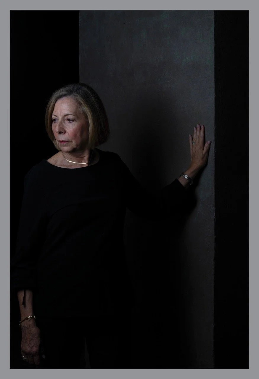 Alice Greenwald in somber mood with hand on wall