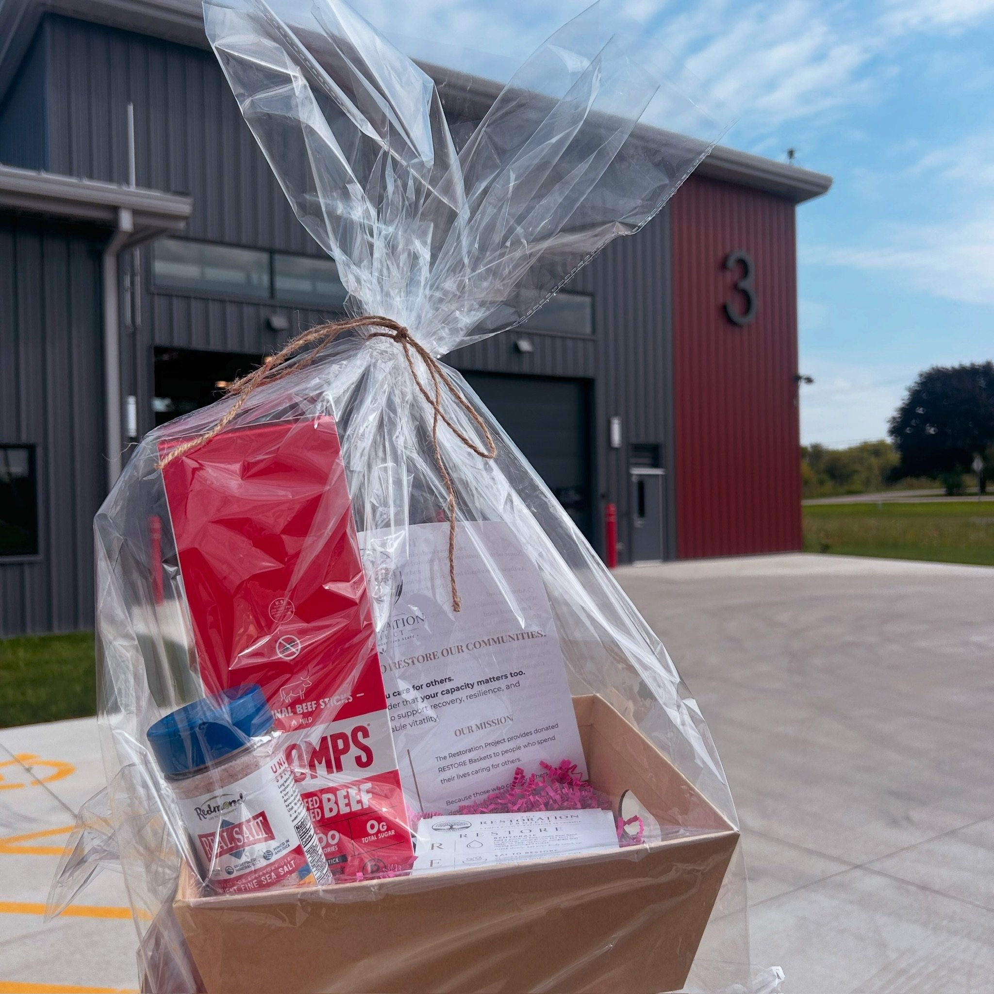 Wrapped RESTORE basket from The Restoration Project by N&T, supporting firefighter nourishment and recovery.