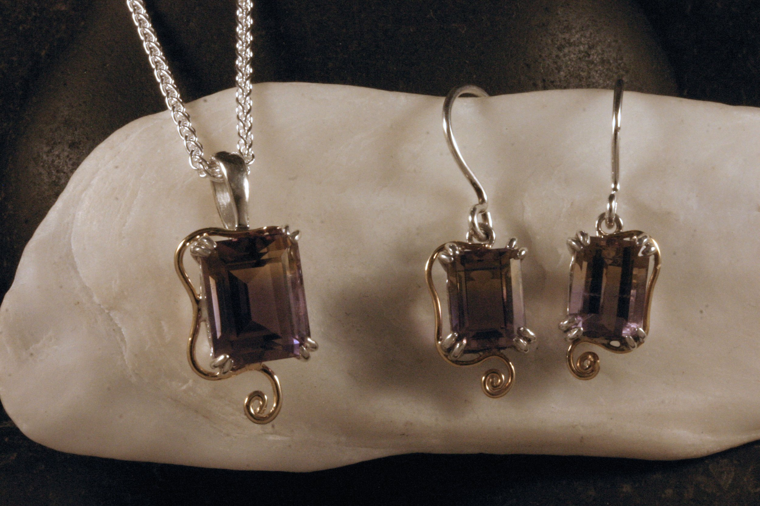 A matched set of sterling silver & 14K gold ametrine earrings & a pendant.