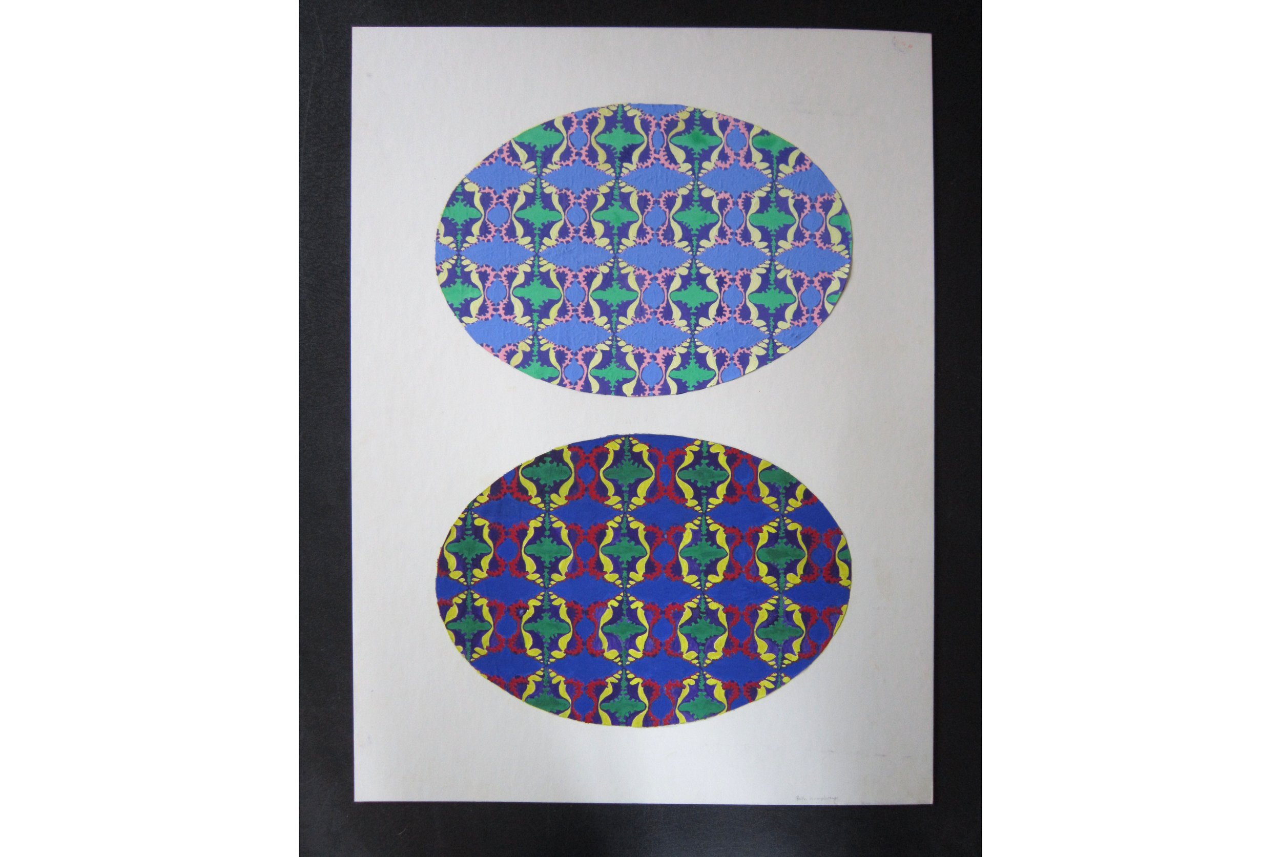 A two oval gouache painting of a conch shell pattern shown on a black table top.