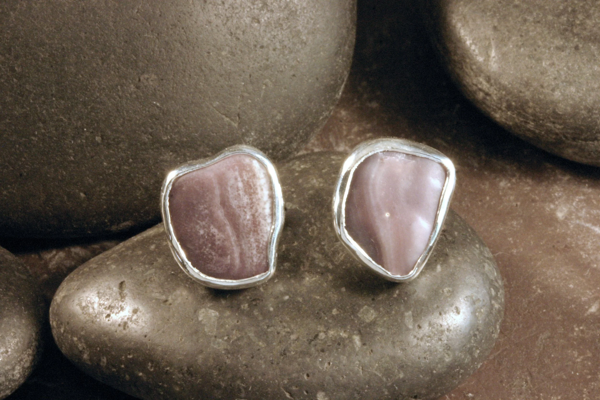 A front view of small sterling silver wampum freeform studs.