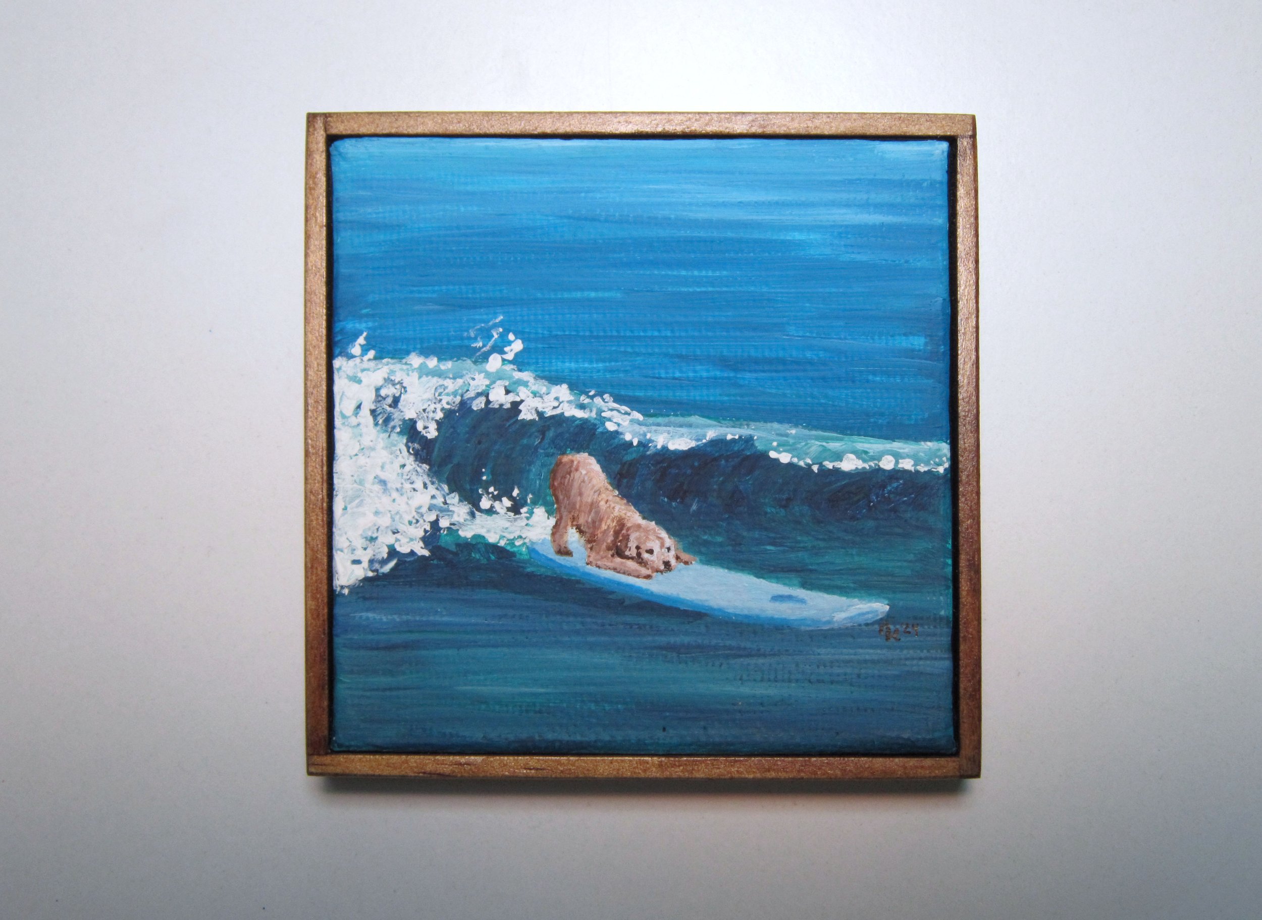 A mini framed acrylic painting of a dog surfing on a breaking wave.