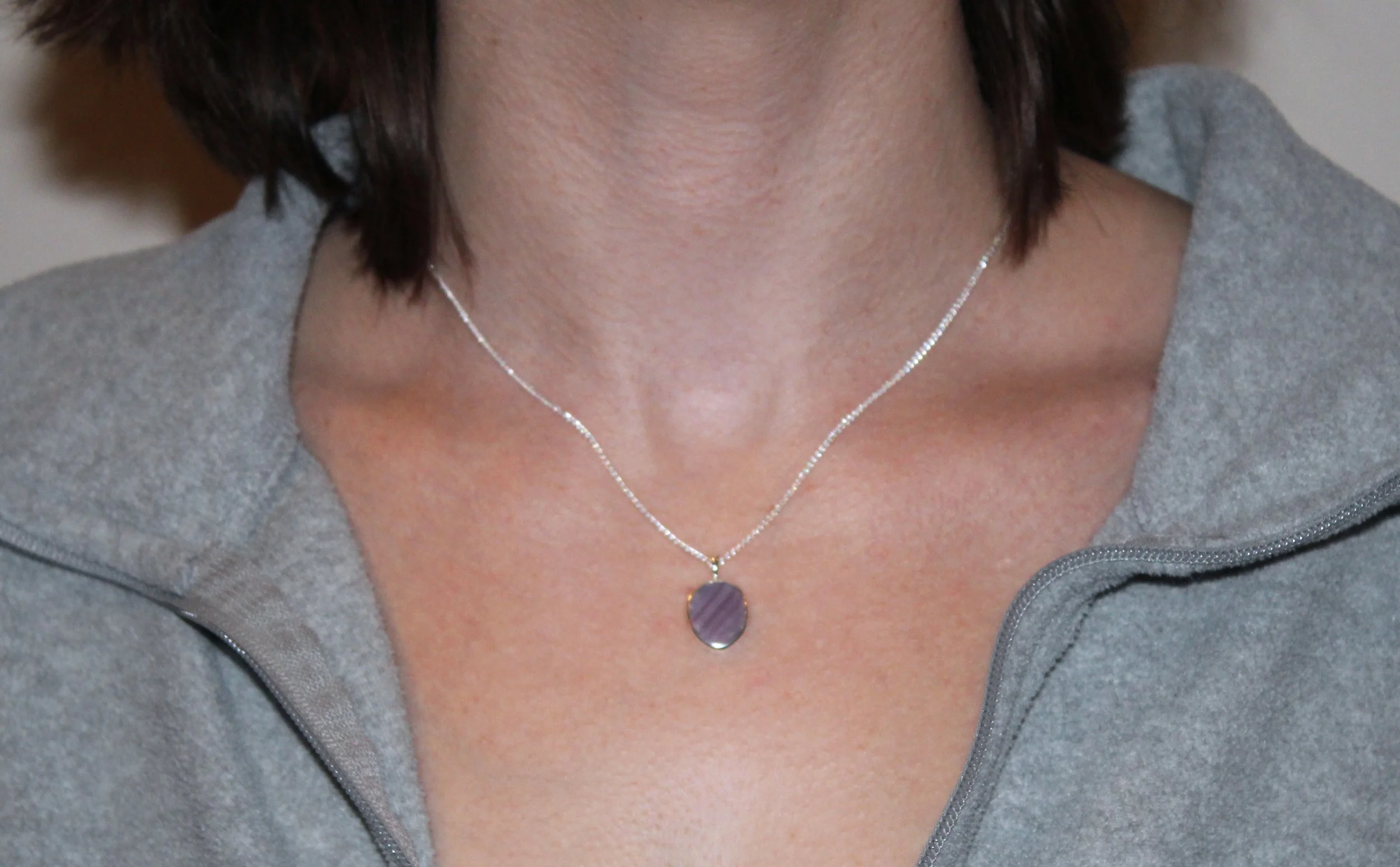 A model wearing a sterling silver wampum necklace.