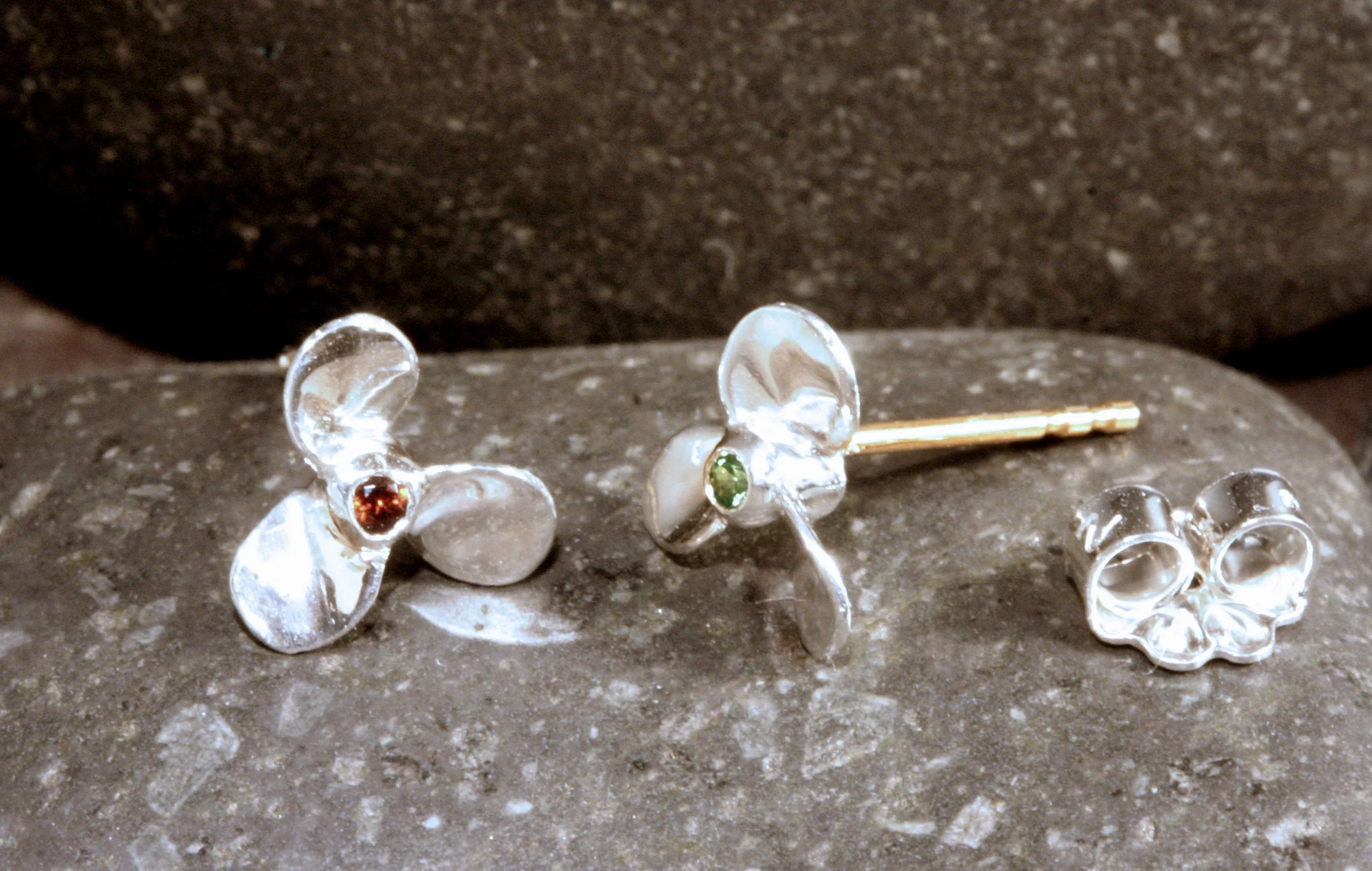 Sterling silver mini propeller earrings with 14K gold posts and red & green garnets in the center for port & starboard.