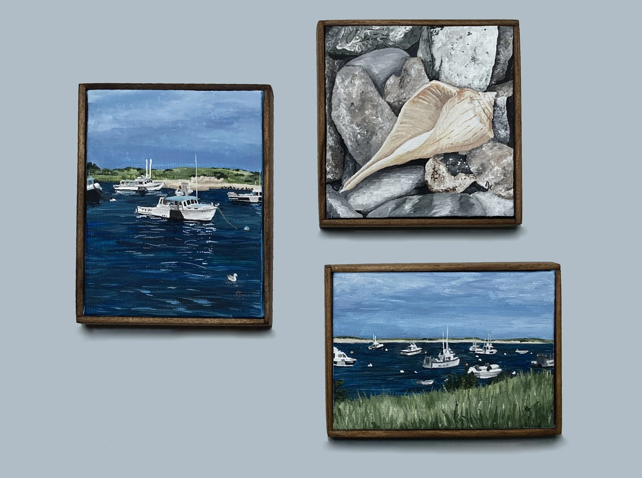 Three miniature framed acrylic paintings with a boat scene, a whelk shell, and a boats & beachgrass scene.
