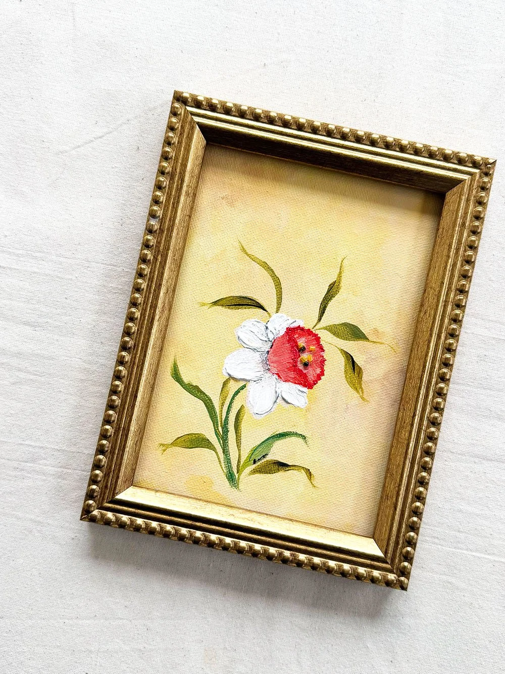Old World Romantic floral art by Ramya Rajiv featuring a textured white and orange daffodil.