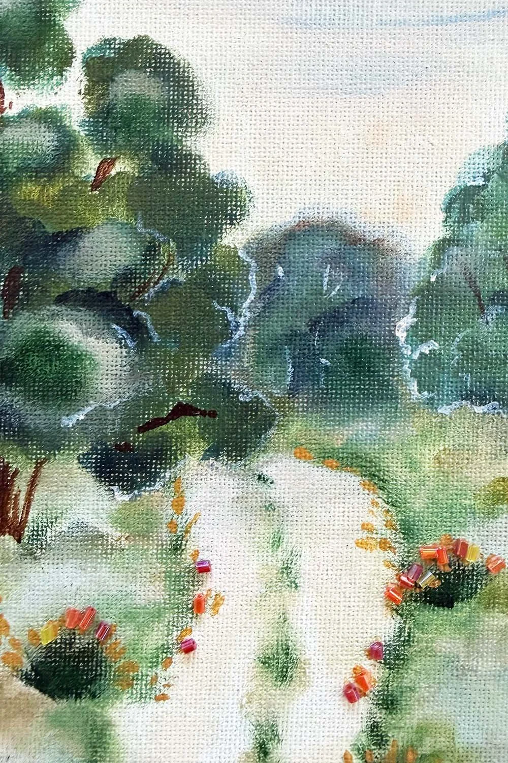 Close-up of a textured landscape painting featuring orange and red glass beads embedded in the foreground to create a shimmering, tactile earth effect.