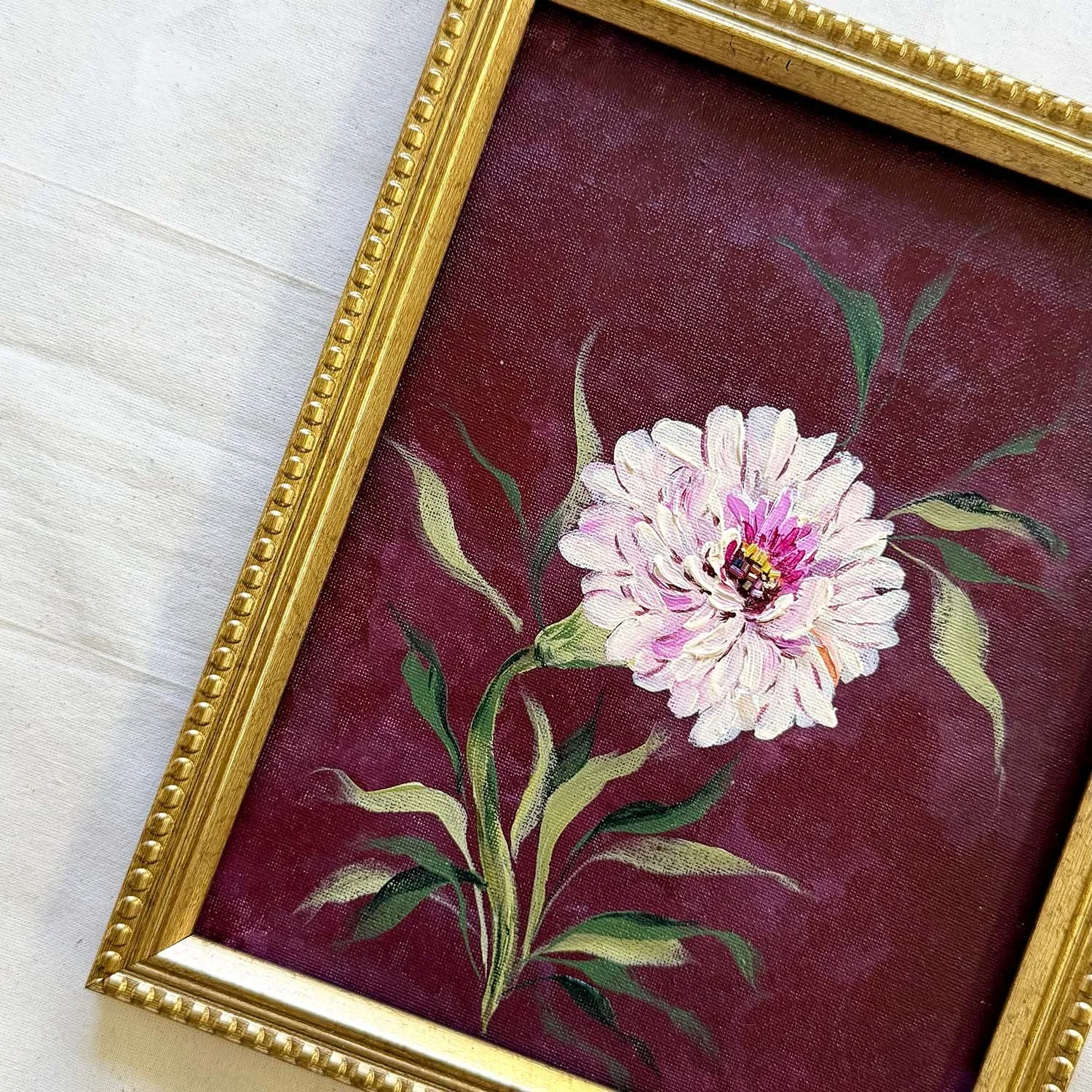 Moody botanical wall art with dark background and ornate gold framing.