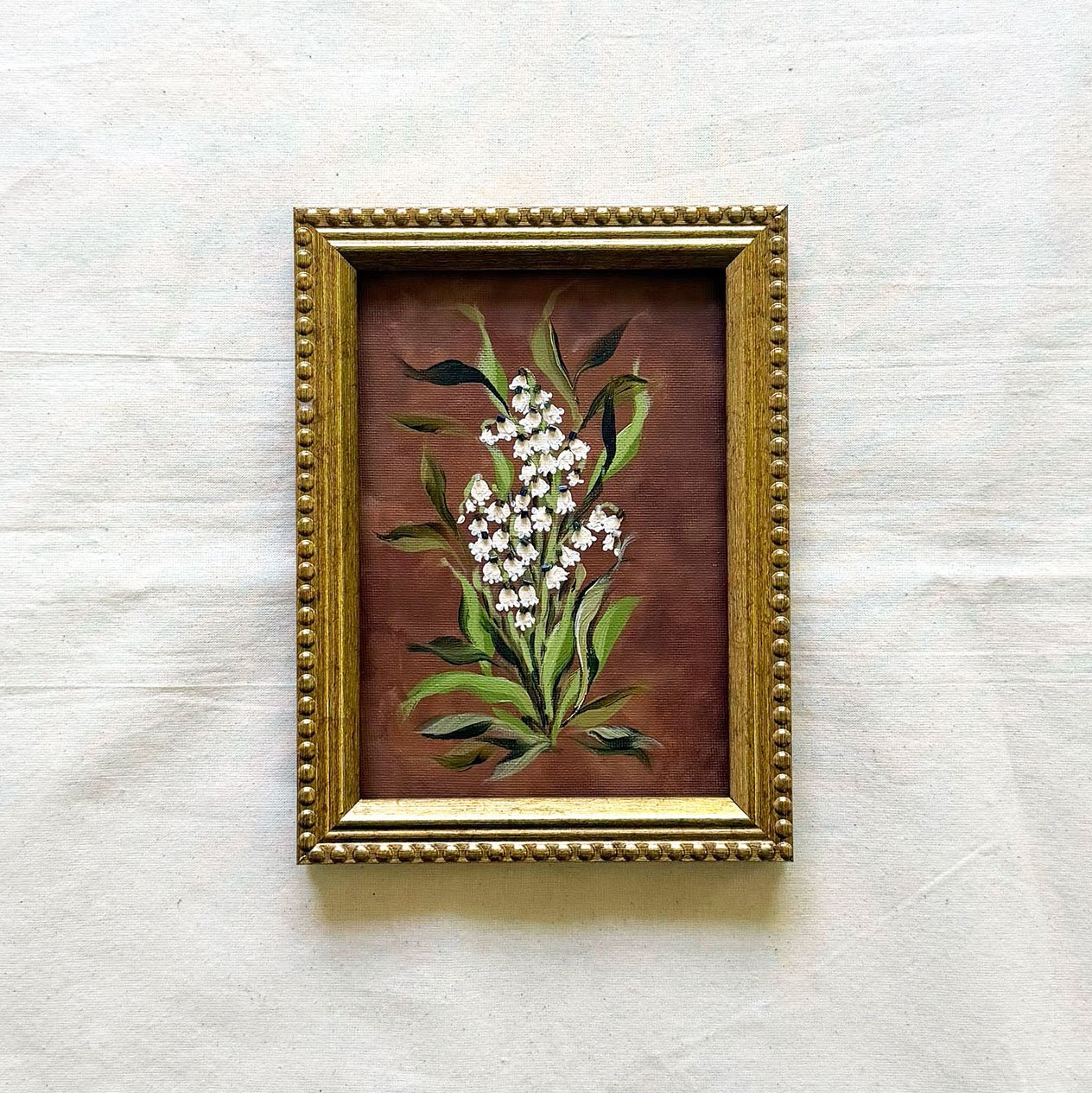 5x7 framed original botanical canvas artwork of white lily of the valley flowers.