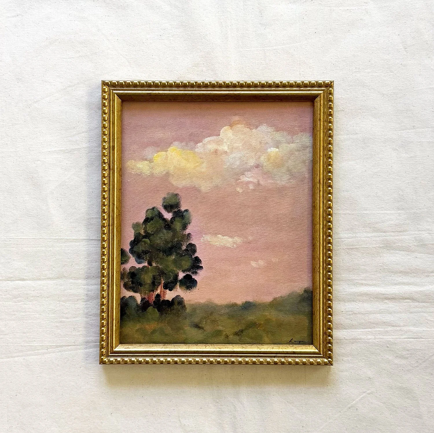 Framed original painting of a tree at sunset with pink clouds.