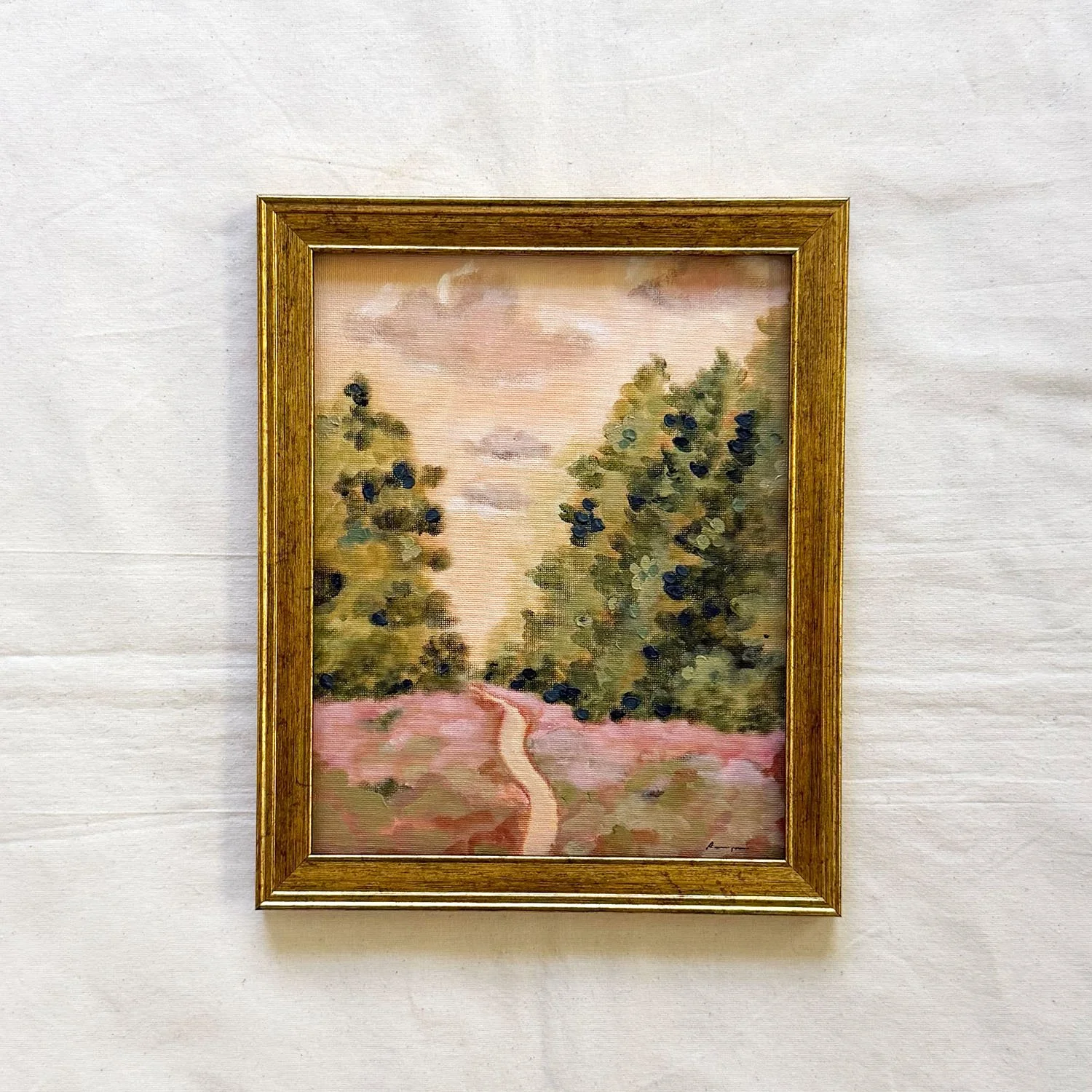 Original painting of a garden path with lush trees in gold frame.