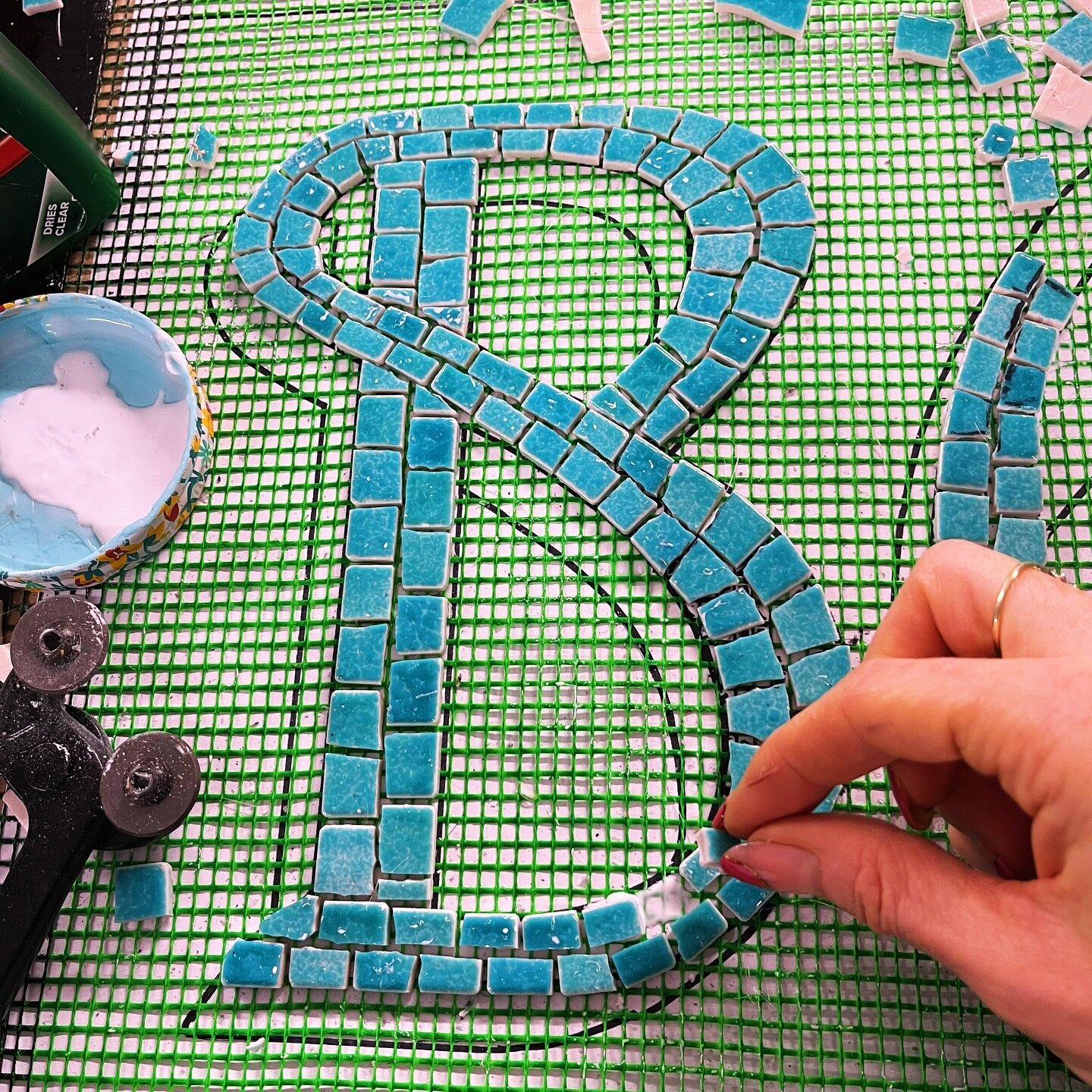 Working on a new mosaic with the lettering being inspired by Spanish signage. I wanted the tiles to intersect the stem of the letter to add a nice flow to the mosaic. I stick the hand cut mosaic tiles onto fibreglass mesh with regular wood glue. And 