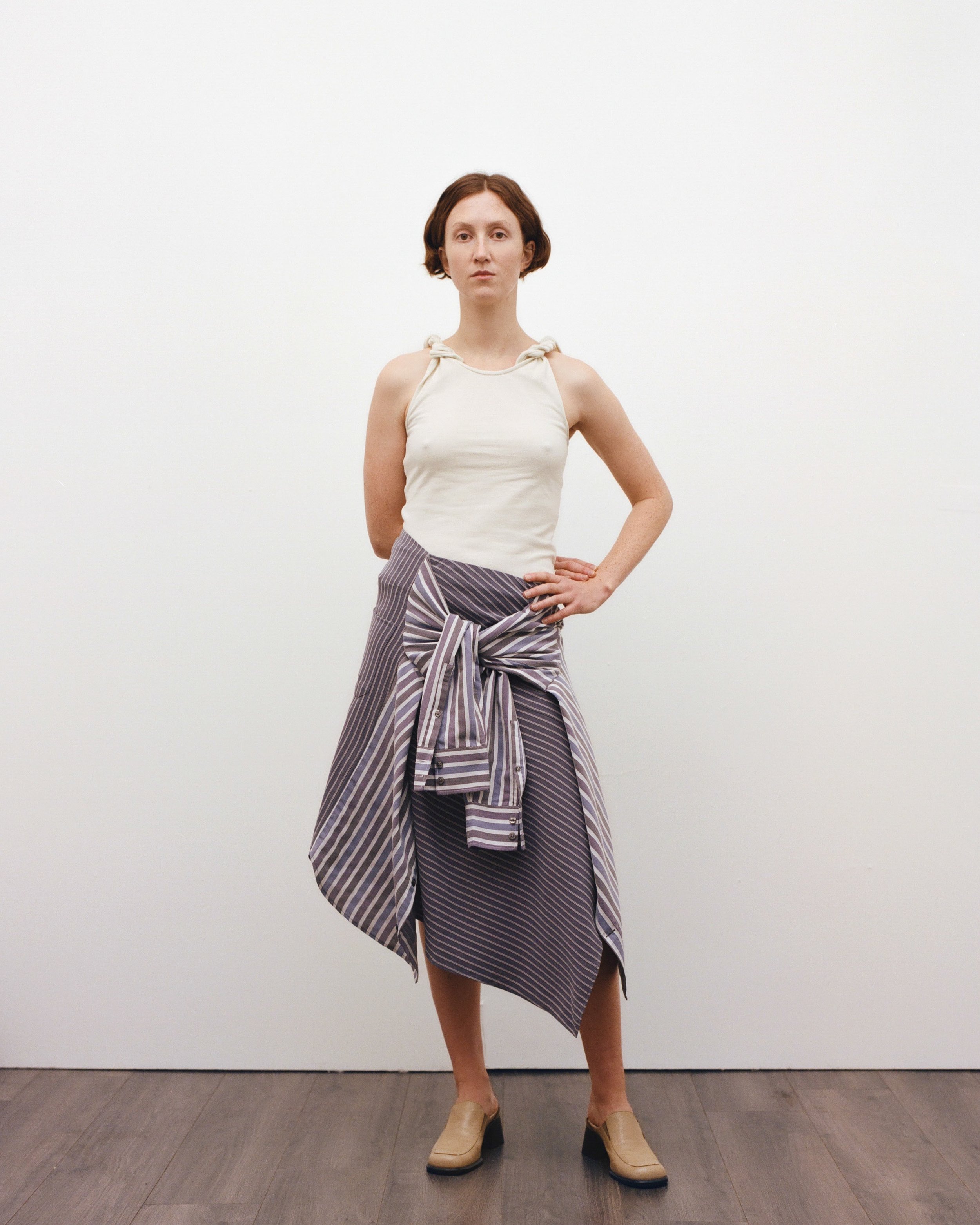 Look 8. Imogen wears the Up-cycled Twist Tank Top and Shirt Skirt, crafted from one repurposed rugby shirt and two shirts sourced from Scope Totnes and Crisis UK