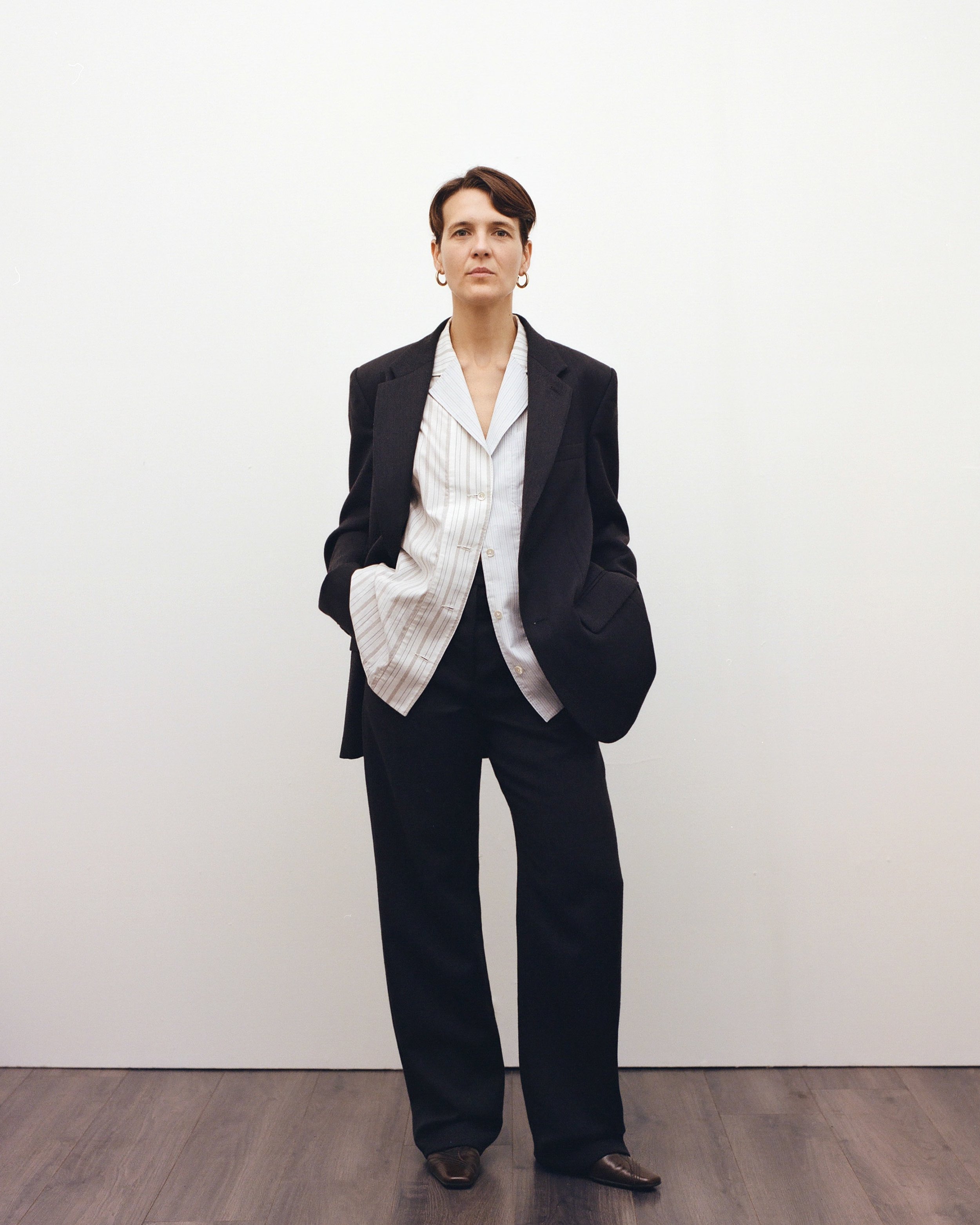 Look 3. Carol wears Collection 06 Unisex Tailored Suit and Collection 04 Up-cycled Sleeveless Shirt crafted from responsibly sourced wool and two repurposed shirts sourced on a trip to Céret in 2019