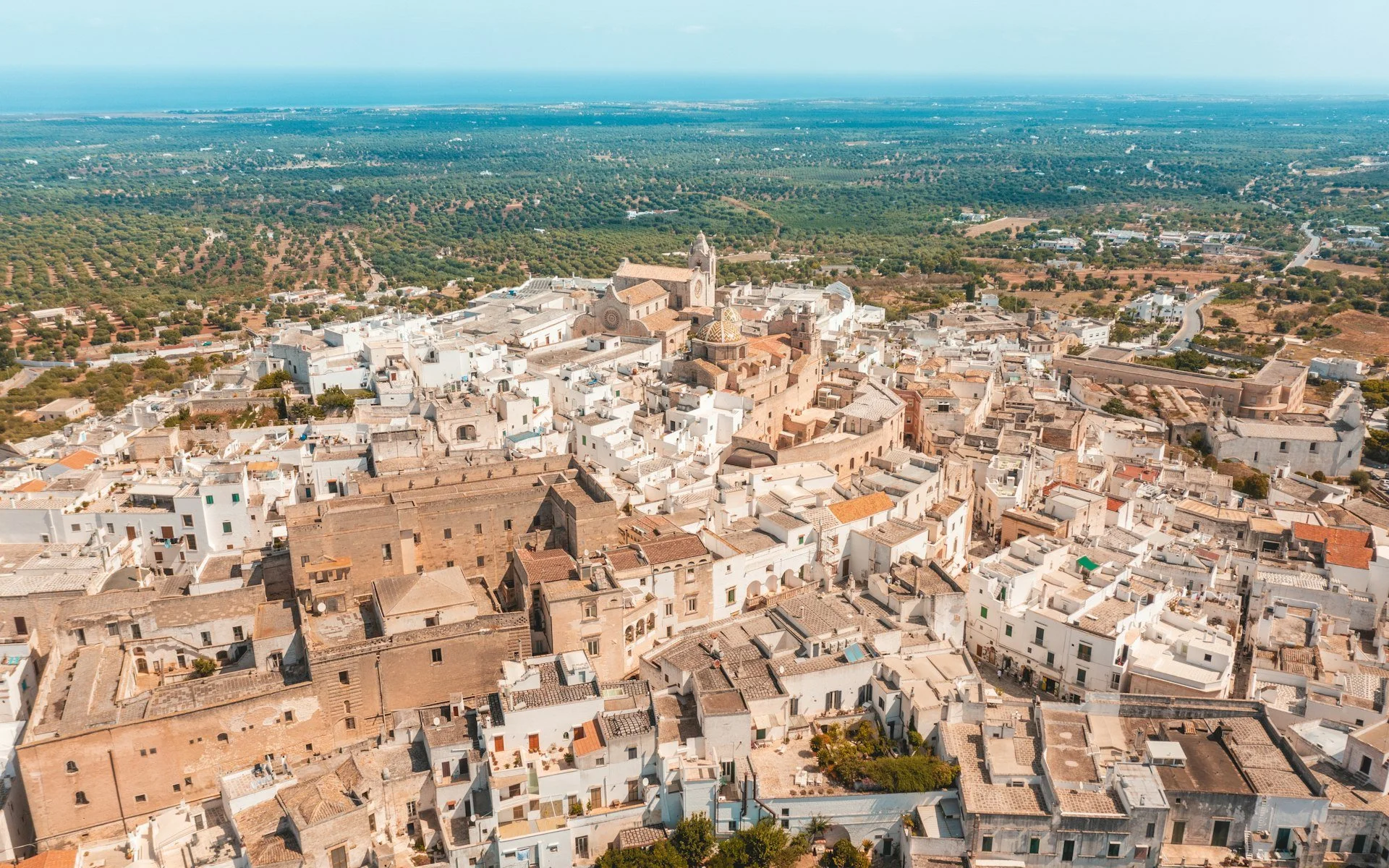 Whitewashed Ostuni on its hilltop above olive groves in Puglia