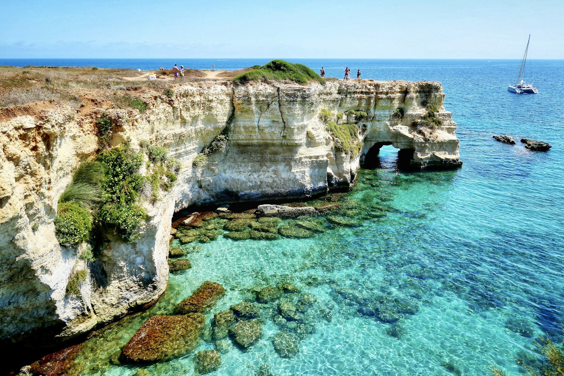 Limestone sea arch and turquoise water at Torre Sant'Andrea, Salento