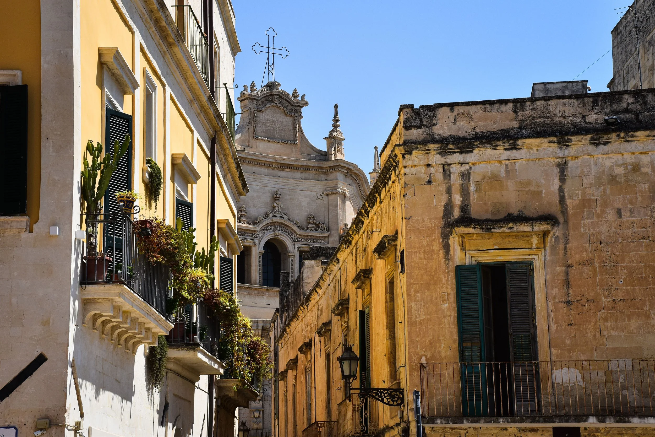 Golden limestone street and Baroque bell tower in Lecce's old town