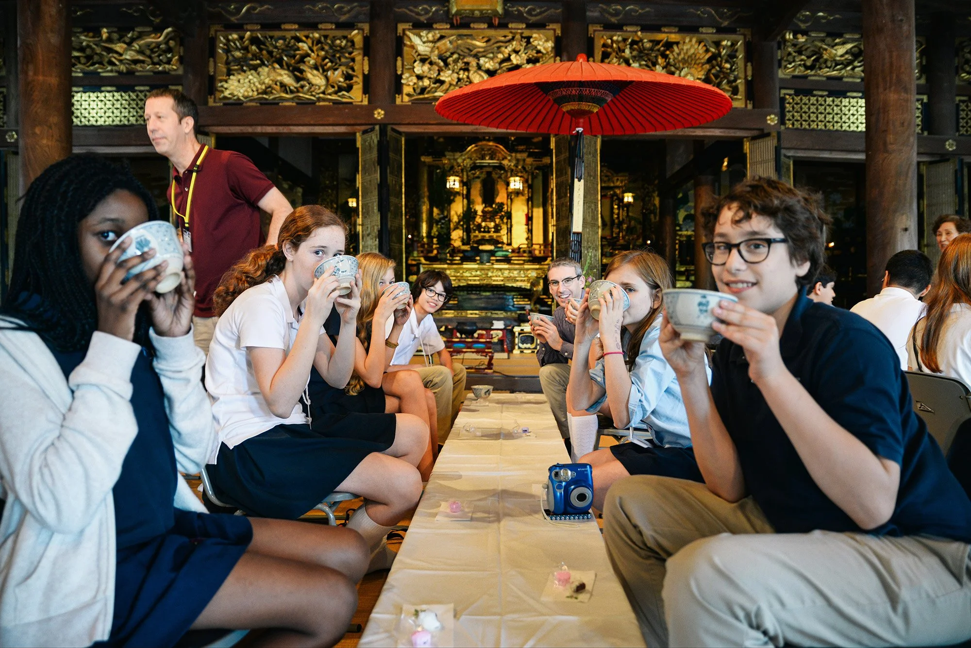 American students and teacher drinking matcha in a temple in Japan