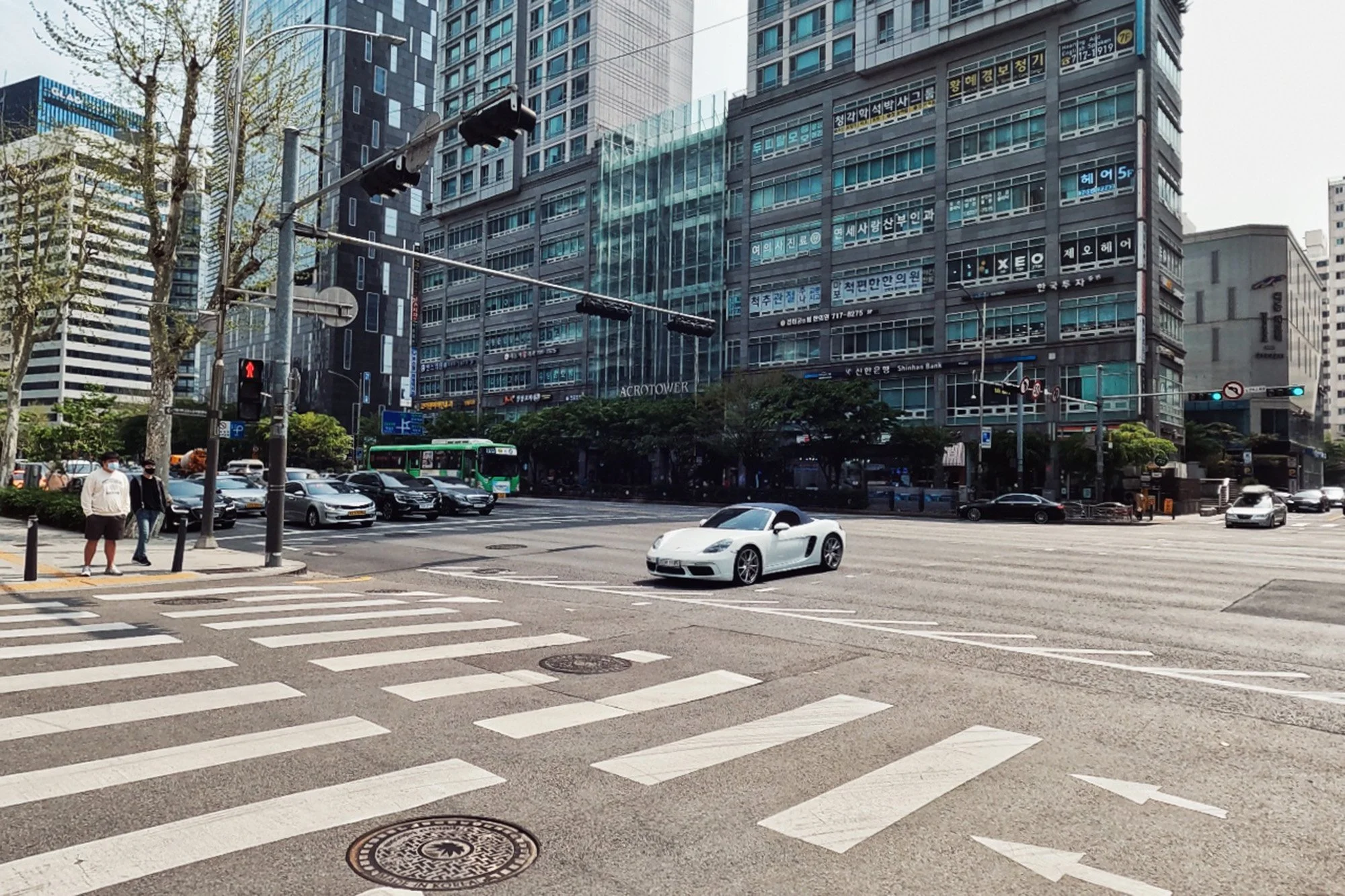 white porsche car driving through intersection in gondeok mapo seoul